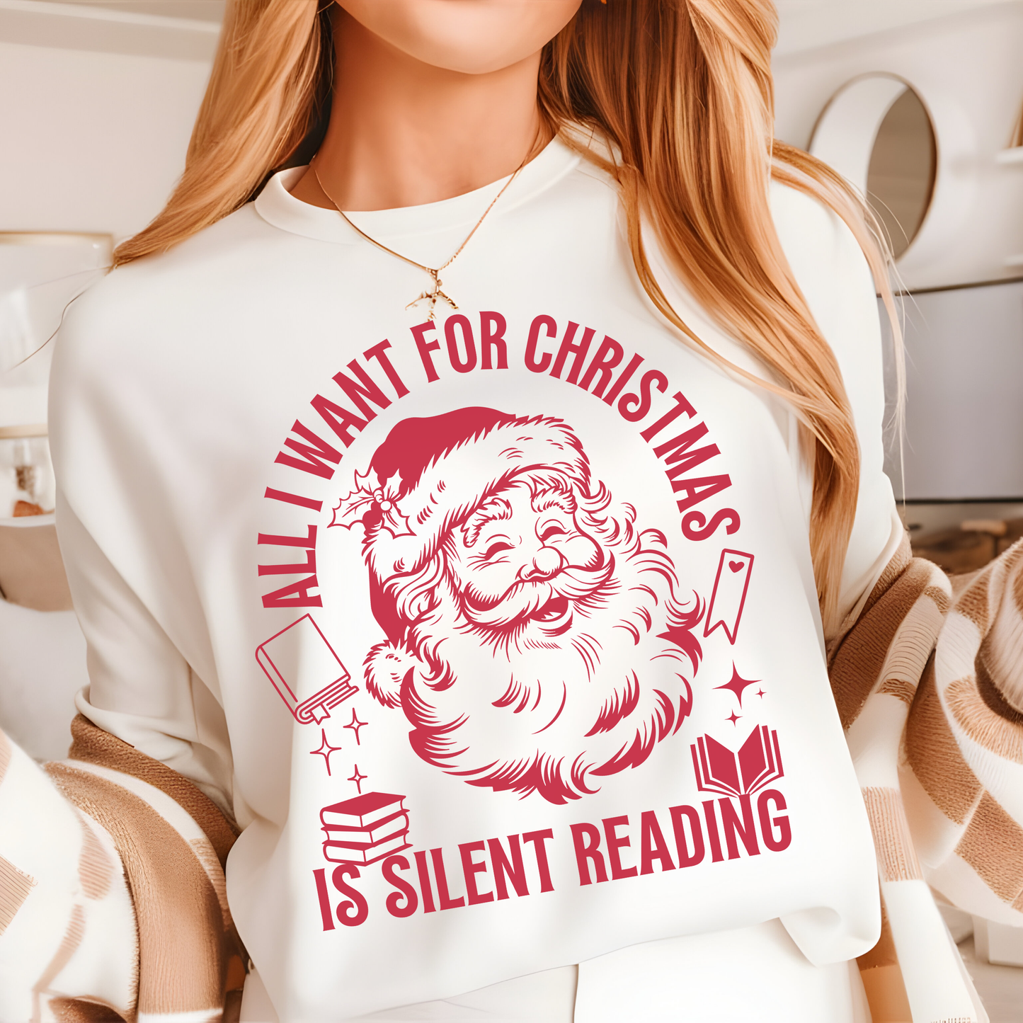 Woman wearing a white holiday shirt featuring a vintage Santa graphic and the phrase “All I Want for Christmas Is Silent Reading"