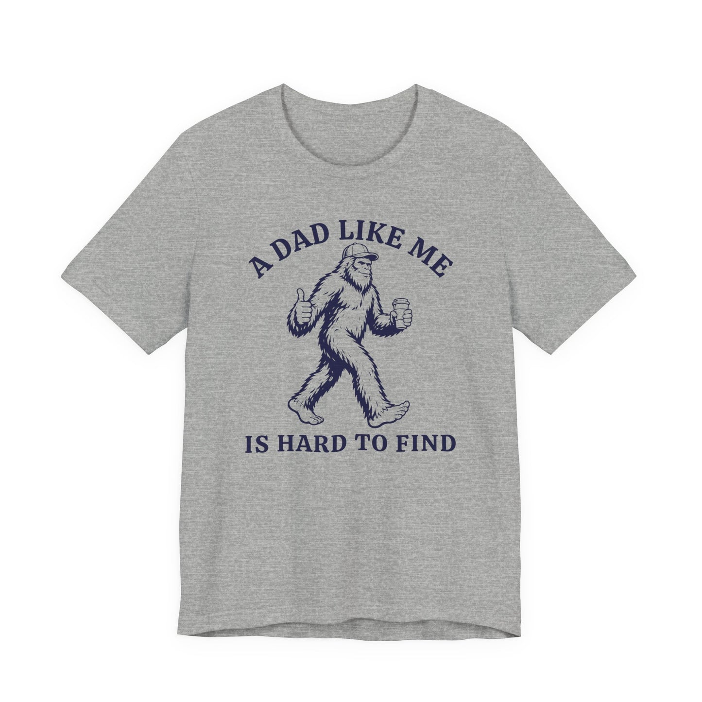 Bella + Canvas 3001 t-shirt in athletic heather grey featuring a funny Bigfoot dad design with a Sasquatch holding a coffee cup and giving a thumbs up alongside the phrase “A Dad Like Me Is Hard To Find” in dark navy lettering.