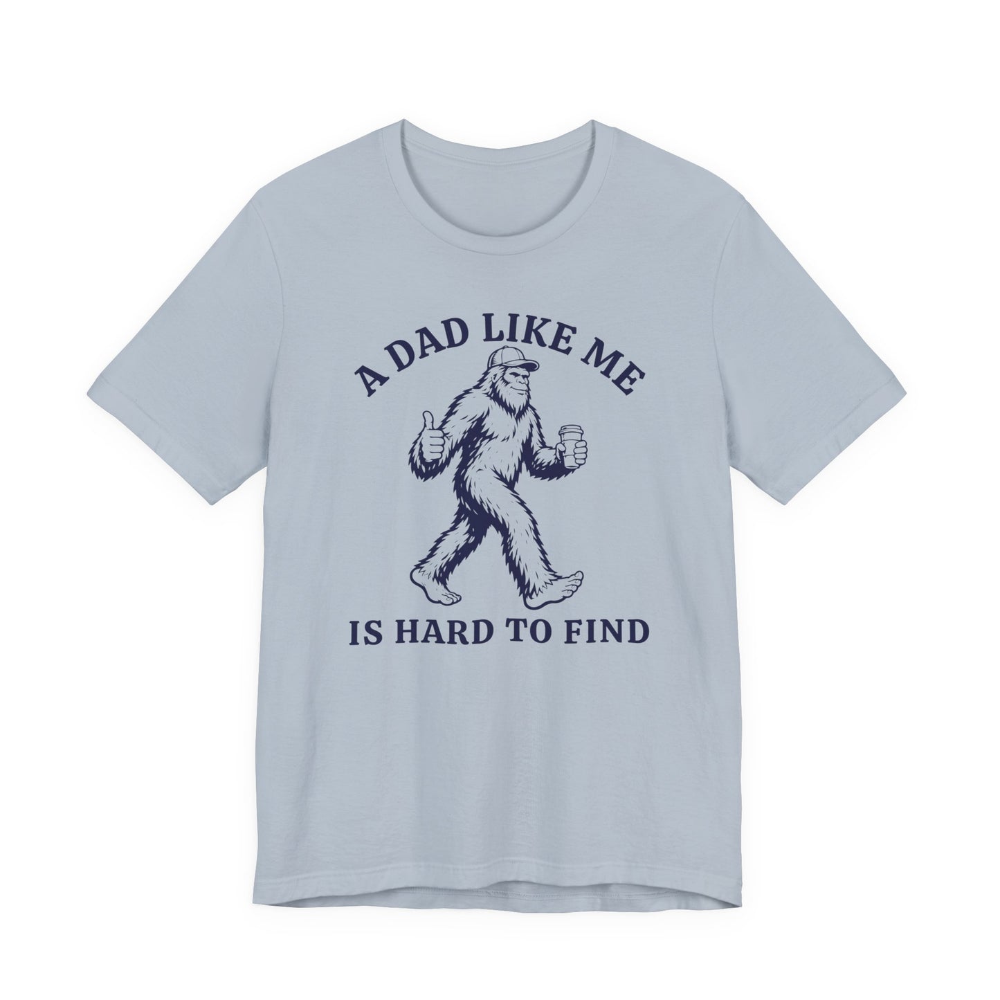 Bella + Canvas 3001 t-shirt in baby blue featuring a funny Bigfoot dad design with a Sasquatch holding a coffee cup and giving a thumbs up alongside the phrase “A Dad Like Me Is Hard To Find” in dark navy lettering.