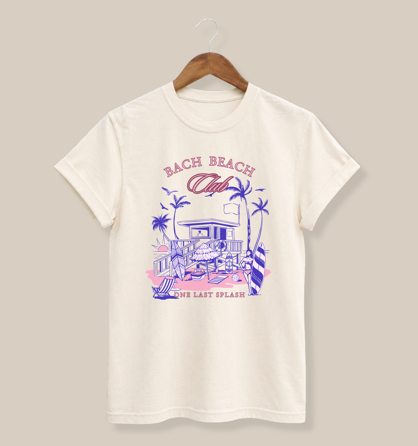 Bella + Canvas 3001 t-shirt in natural featuring a retro beach bachelorette design with palm trees, surfboards, a beach house, and “Bach Beach Club, One Last Splash” wording in pink and blue tropical lettering.