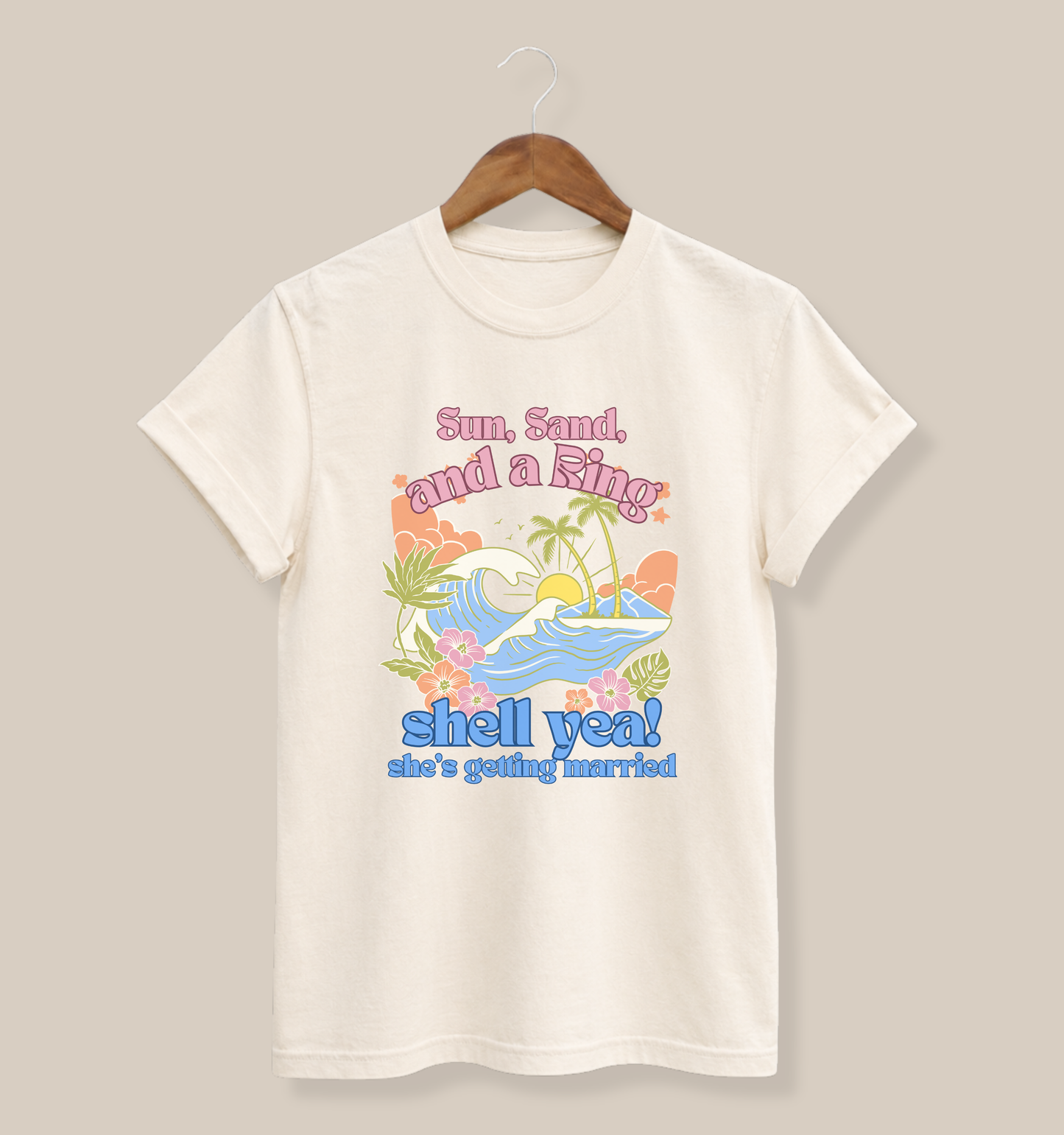 Bella + Canvas 3001 t-shirt in natural featuring a tropical beach bachelorette design with ocean waves, palm trees, hibiscus flowers, and “Sun, Sand, and a Ring, Shell Yeah! She’s Getting Married” retro vacation-inspired wording.