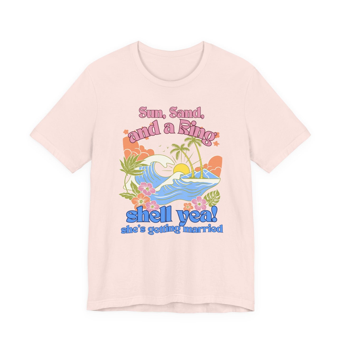 Bella + Canvas 3001 t-shirt in soft pink featuring a colorful tropical beach bachelorette party design with ocean waves, palm trees, hibiscus flowers, and “Sun, Sand, and a Ring, Shell Yeah! She’s Getting Married” retro-inspired wording.