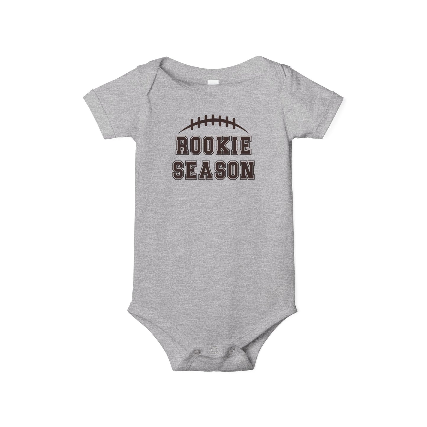 Bella + Canvas 100B athletic heather infant bodysuit featuring a brown football graphic and "Rookie Season" text. Soft baby football outfit perfect for game days, football season, newborn photos, baby showers, and little sports fans.