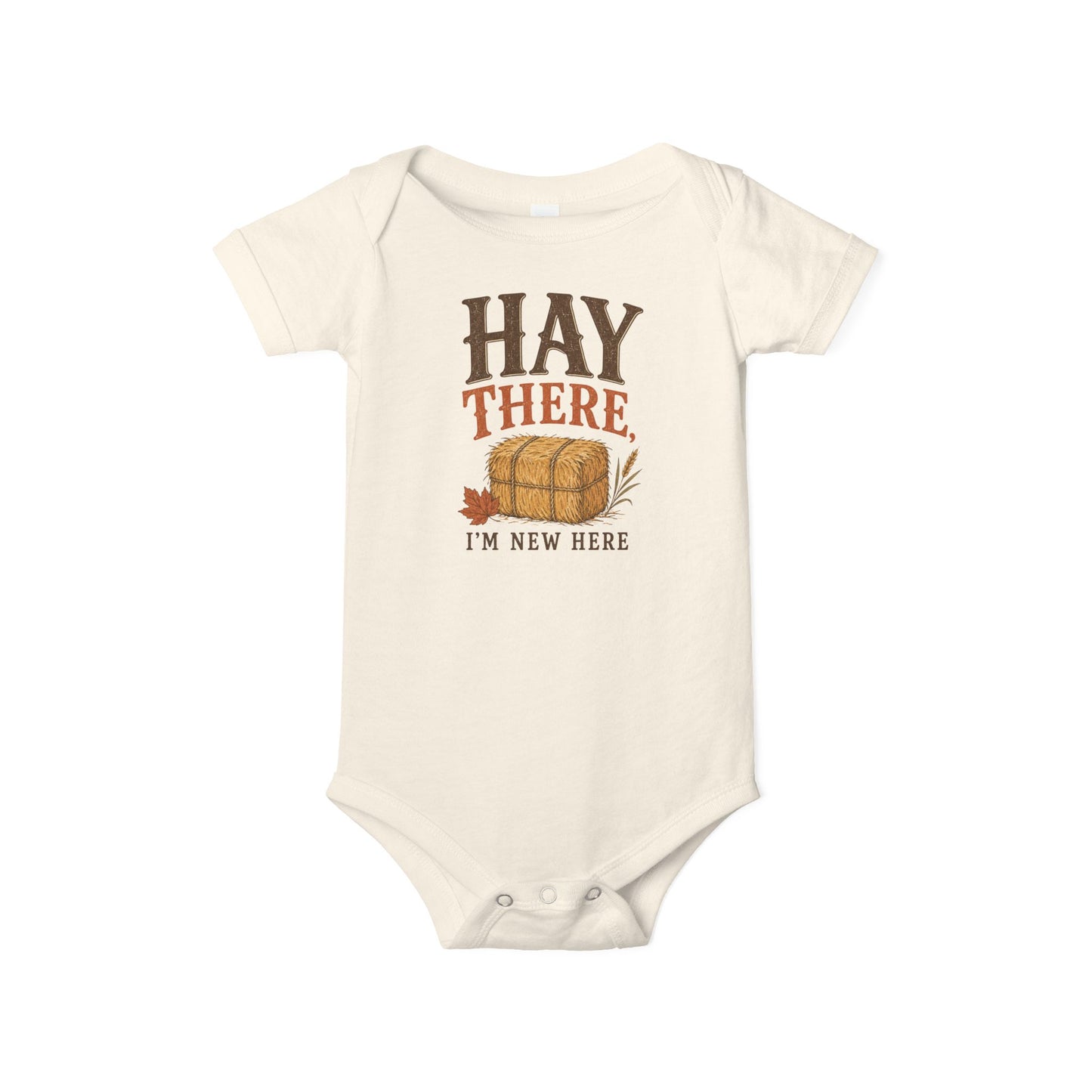 Natural Bella + Canvas 100B infant one piece featuring the phrase "Hay There, I'm New Here" with a hay bale and autumn leaf design. Cute fall baby bodysuit for newborns and infants, perfect for baby's first autumn, pumpkin patch trips, hayrides, baby showers, fall photos, and seasonal celebrations.