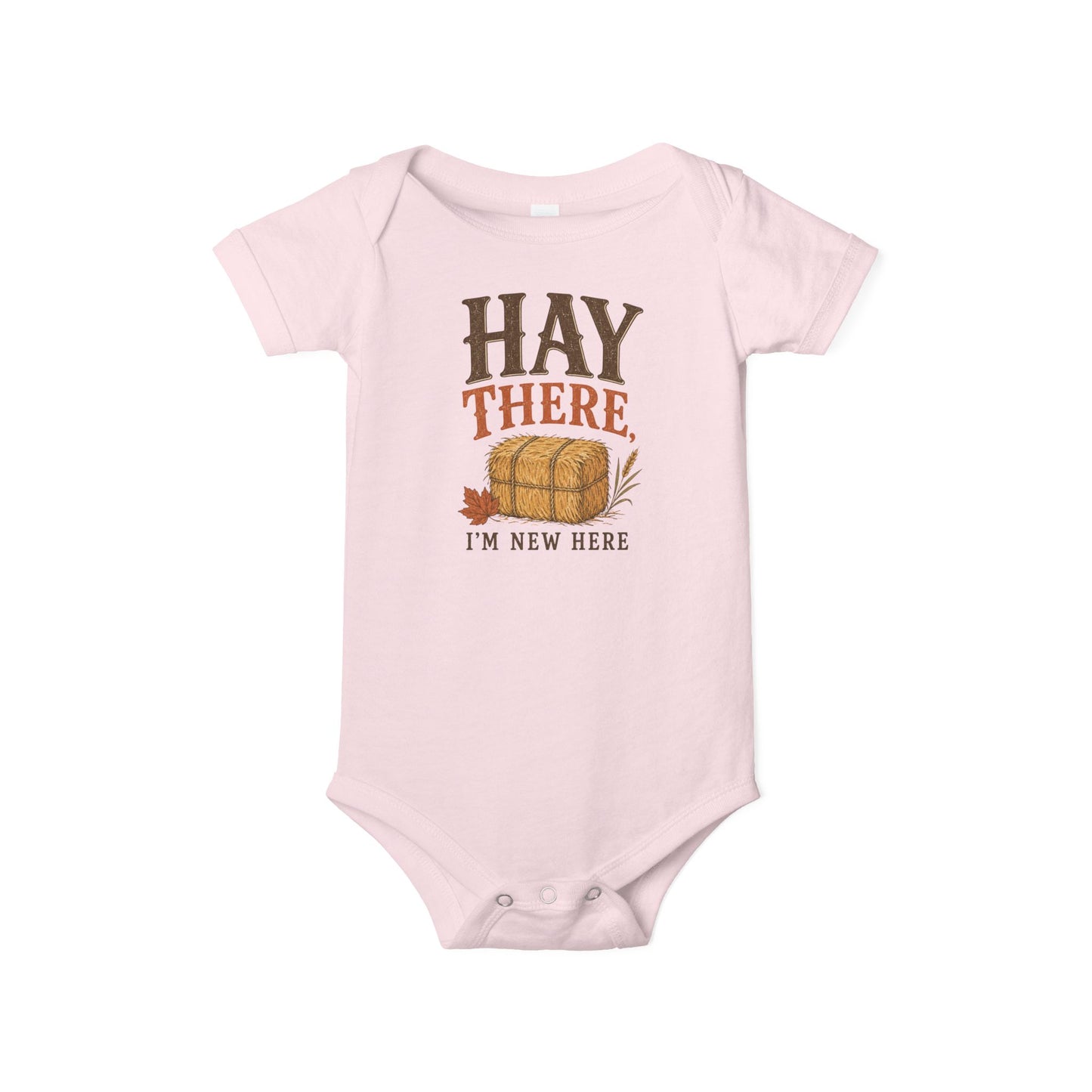 Pink Bella + Canvas 100B infant one piece featuring the phrase "Hay There, I'm New Here" with a hay bale and autumn leaf design. Adorable fall baby bodysuit for newborns and infants, perfect for baby's first fall, pumpkin patch visits, baby showers, autumn photo sessions, and cozy seasonal outfits.