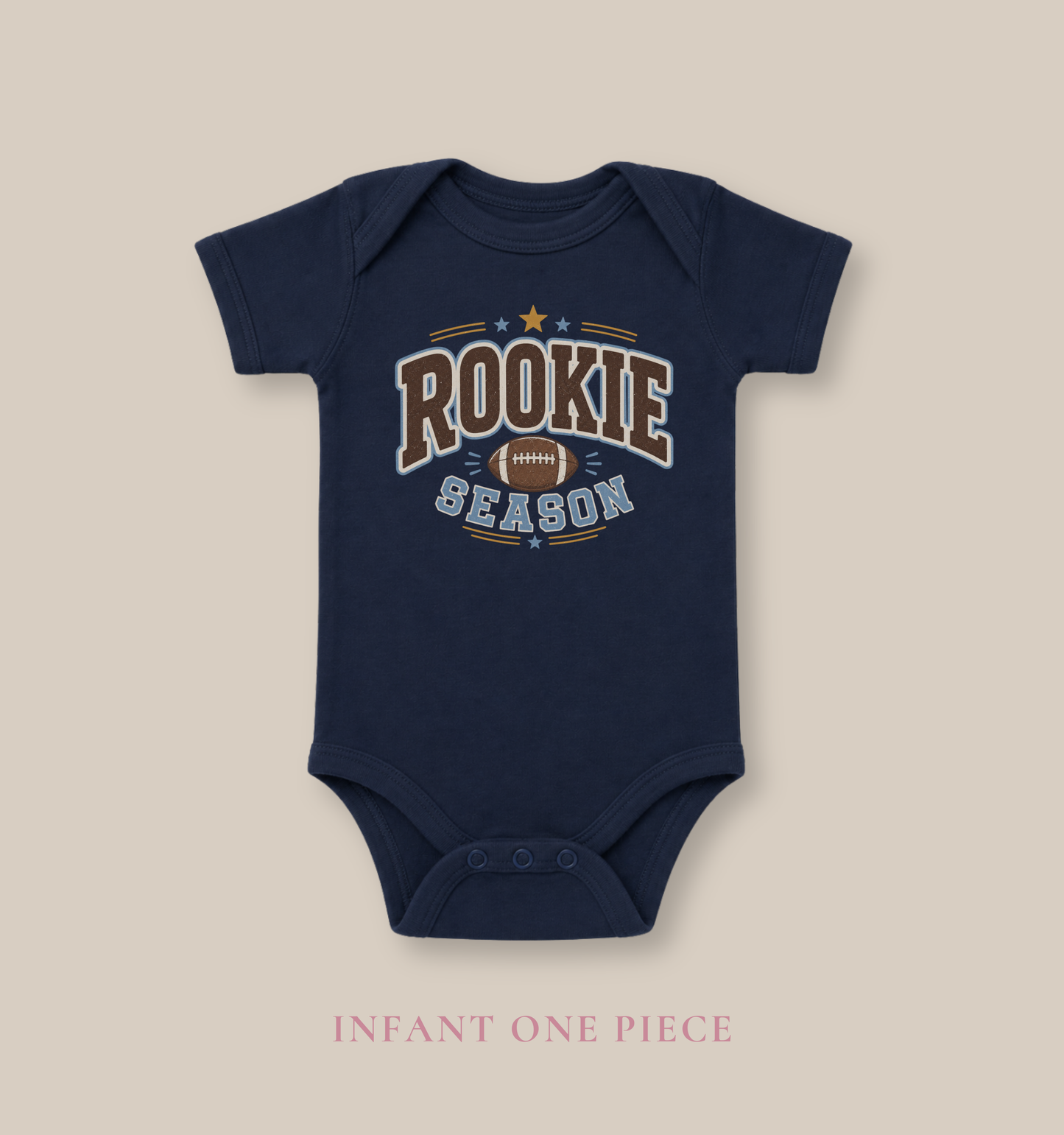 Bella + Canvas 100B infant one piece in Navy featuring a football graphic and the phrase "Rookie Season." Soft football-themed baby bodysuit perfect for newborns, infants, baby's first football season, game days, tailgates, baby showers, and sports-loving families.