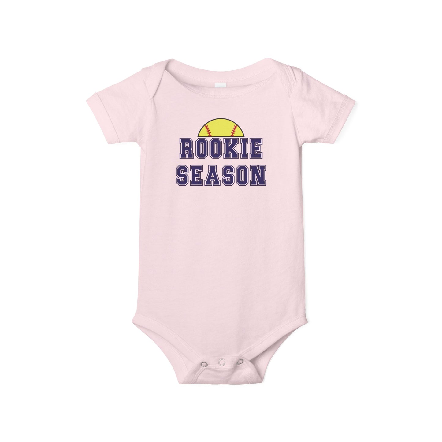 Bella + Canvas 100B pink infant bodysuit featuring a yellow softball graphic and "Rookie Season" text. Cute softball baby outfit for game days, softball families, newborn photos, baby showers, and celebrating baby's first softball season.