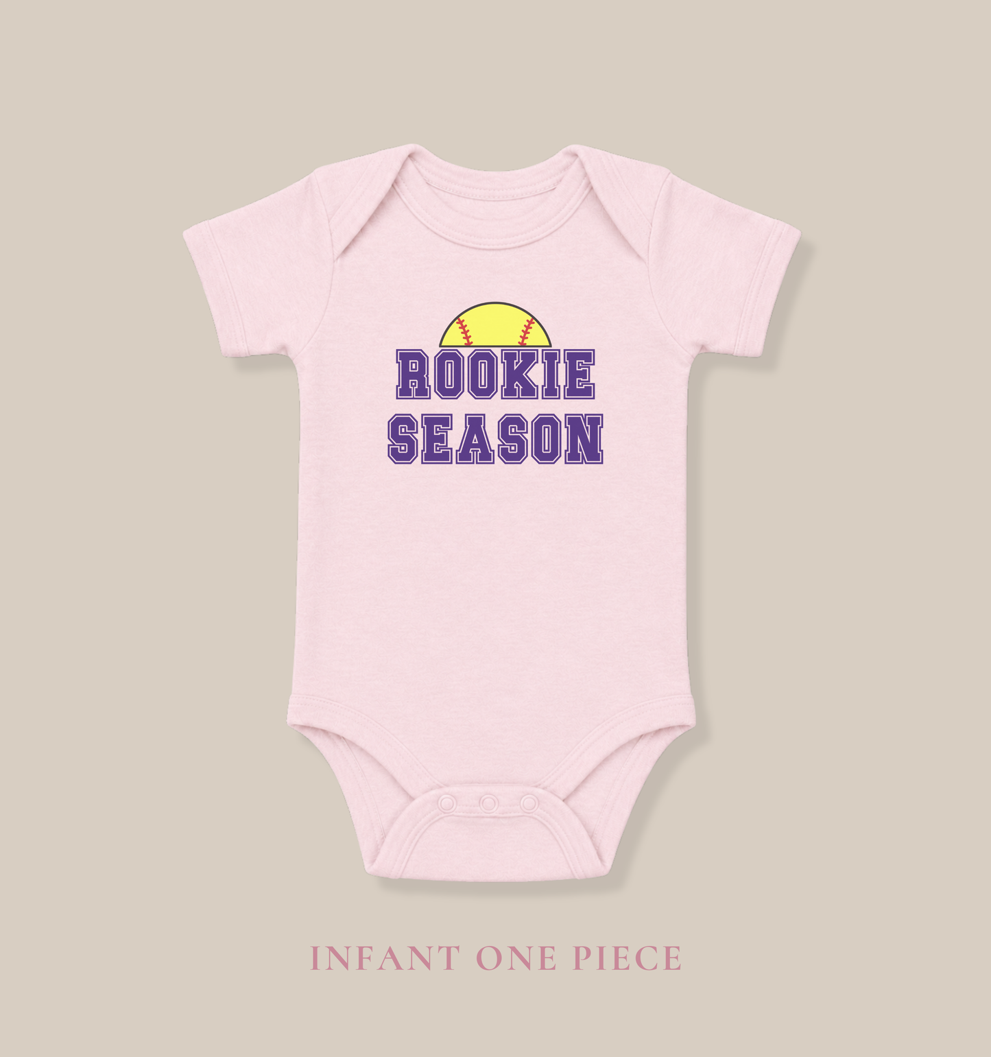 Bella + Canvas 100B pink infant bodysuit featuring a yellow softball graphic and "Rookie Season" text. Cute softball baby outfit perfect for softball season, game days, baby showers, newborn photos, and future softball fans.