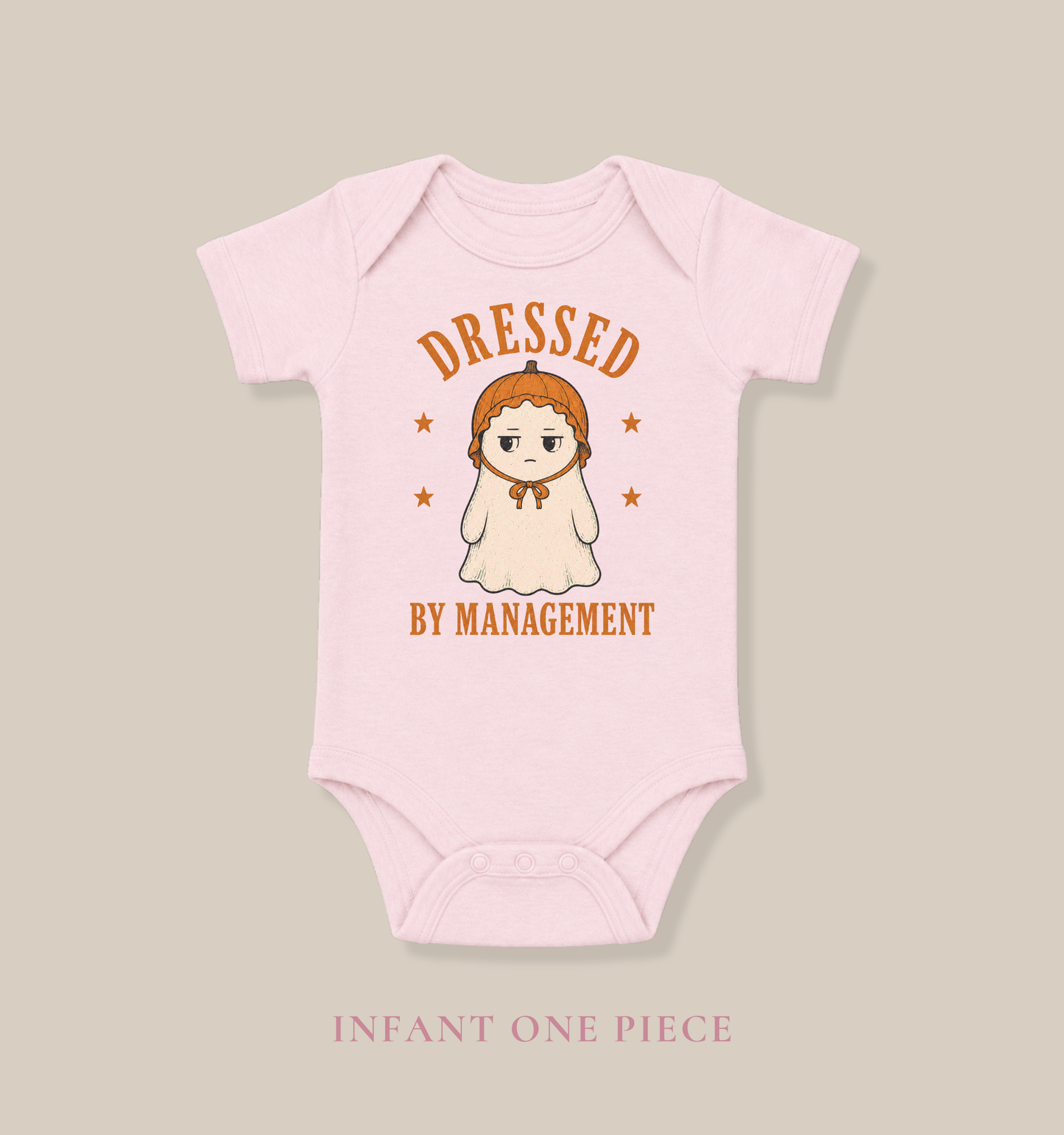 Bella + Canvas 100B infant one piece in Pink featuring a cute ghost wearing a pumpkin bonnet with the phrase "Dressed by Management." Soft Halloween baby one piece perfect for newborns, infants, baby's first Halloween, pumpkin patch visits, fall photos, and spooky season outfits.