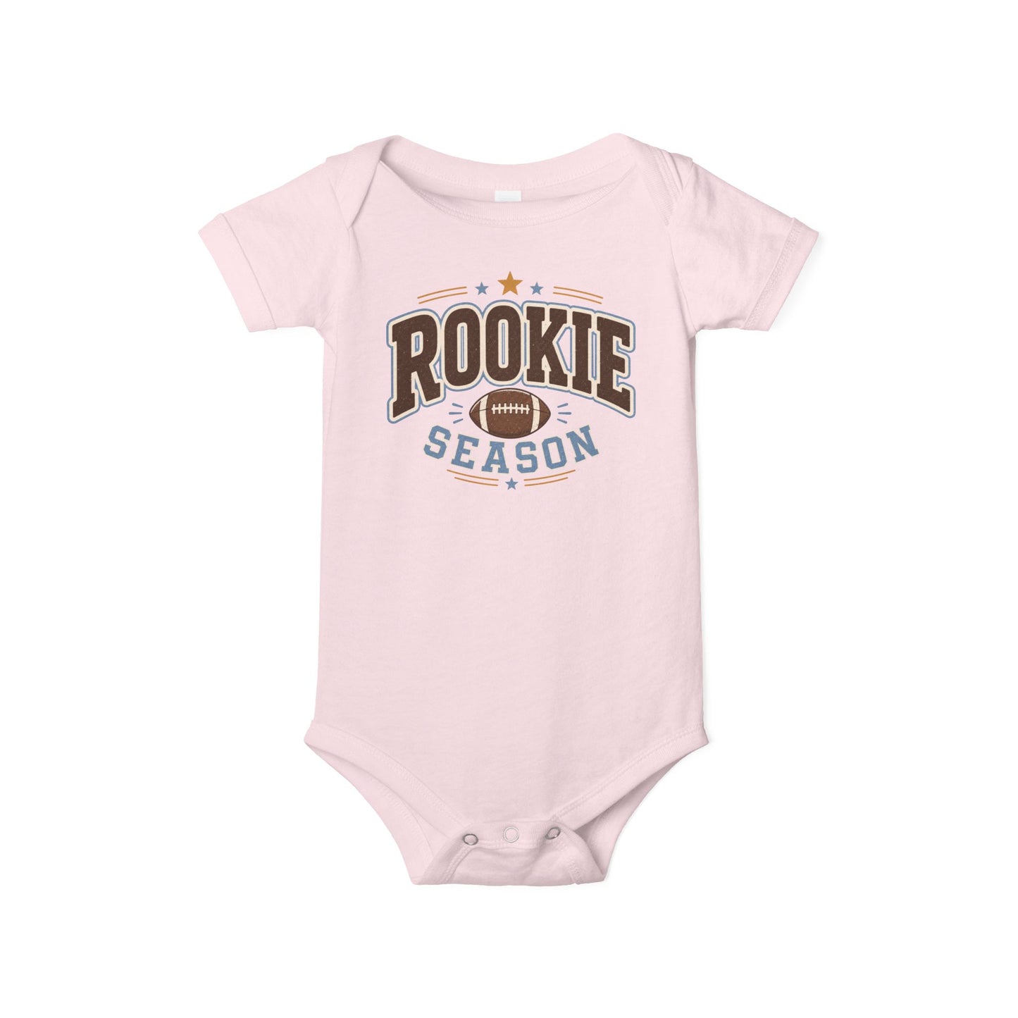 Bella + Canvas 100B infant one piece in Pink featuring a football graphic and the phrase "Rookie Season." Soft football-themed baby bodysuit perfect for newborns, infants, baby girls, baby's first football season, game days, tailgates, baby showers, and sports-loving families.