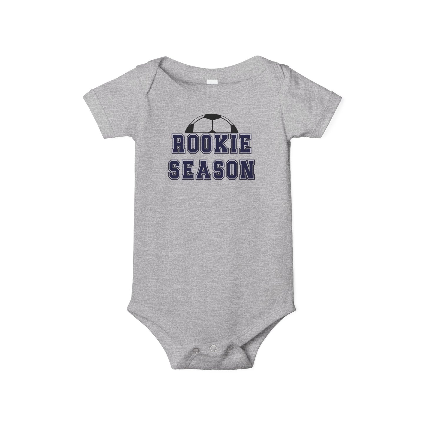 Bella + Canvas 100B baby bodysuit in athletic heather gray featuring the phrase “Rookie Season” in navy varsity lettering with a soccer ball graphic. Soccer-themed infant one-piece for baby boys and girls, perfect for first soccer season, game day outfits, soccer family photos, baby shower gifts, and little future soccer stars.