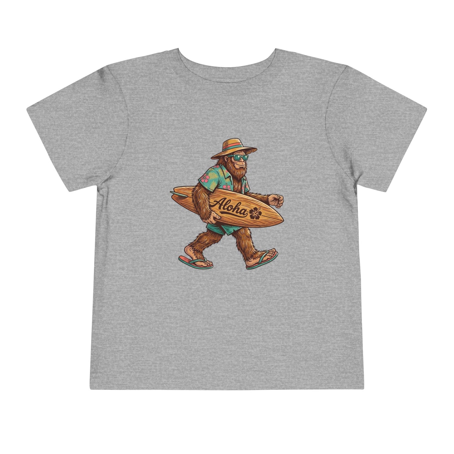 Bella + Canvas 3001T toddler t-shirt in athletic heather grey featuring a tropical Bigfoot wearing sunglasses and flip flops while carrying an “Aloha” surfboard.
