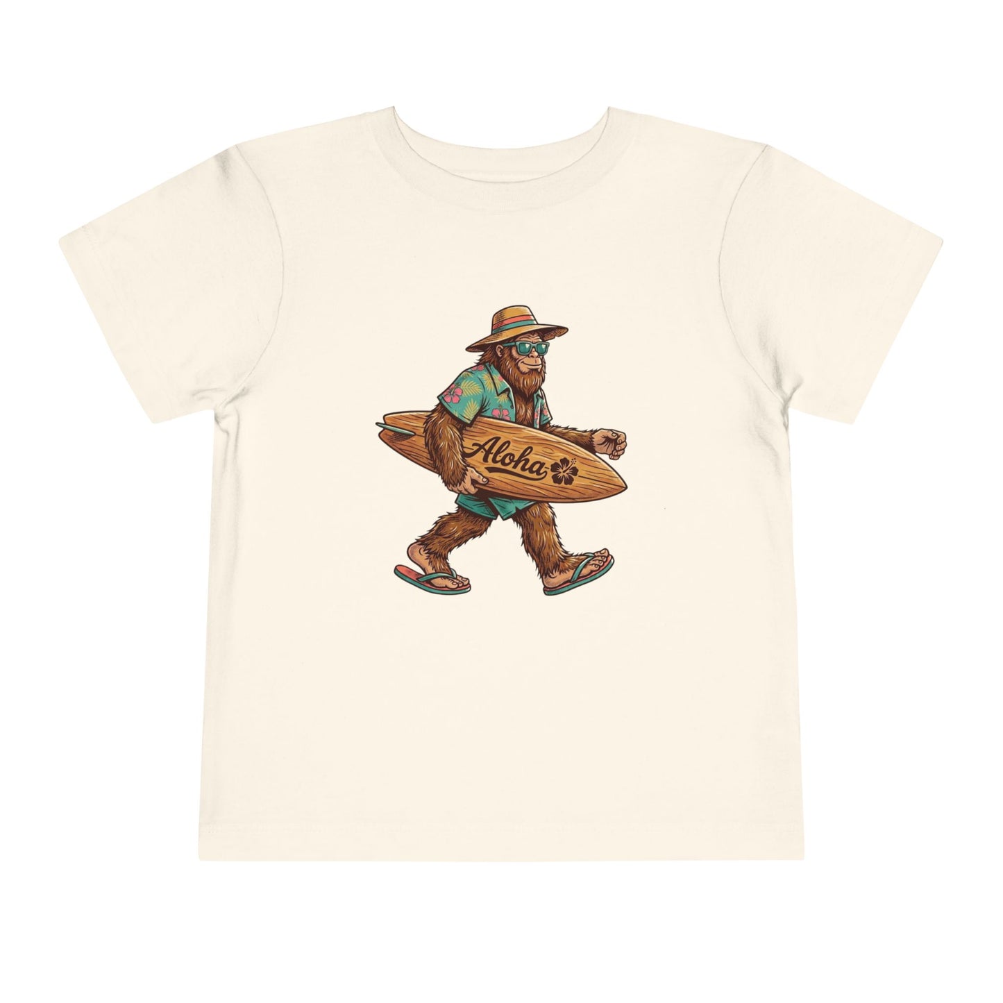 Bella + Canvas 3001T toddler t-shirt in natural featuring a tropical Bigfoot wearing sunglasses and flip flops while carrying an “Aloha” surfboard.

