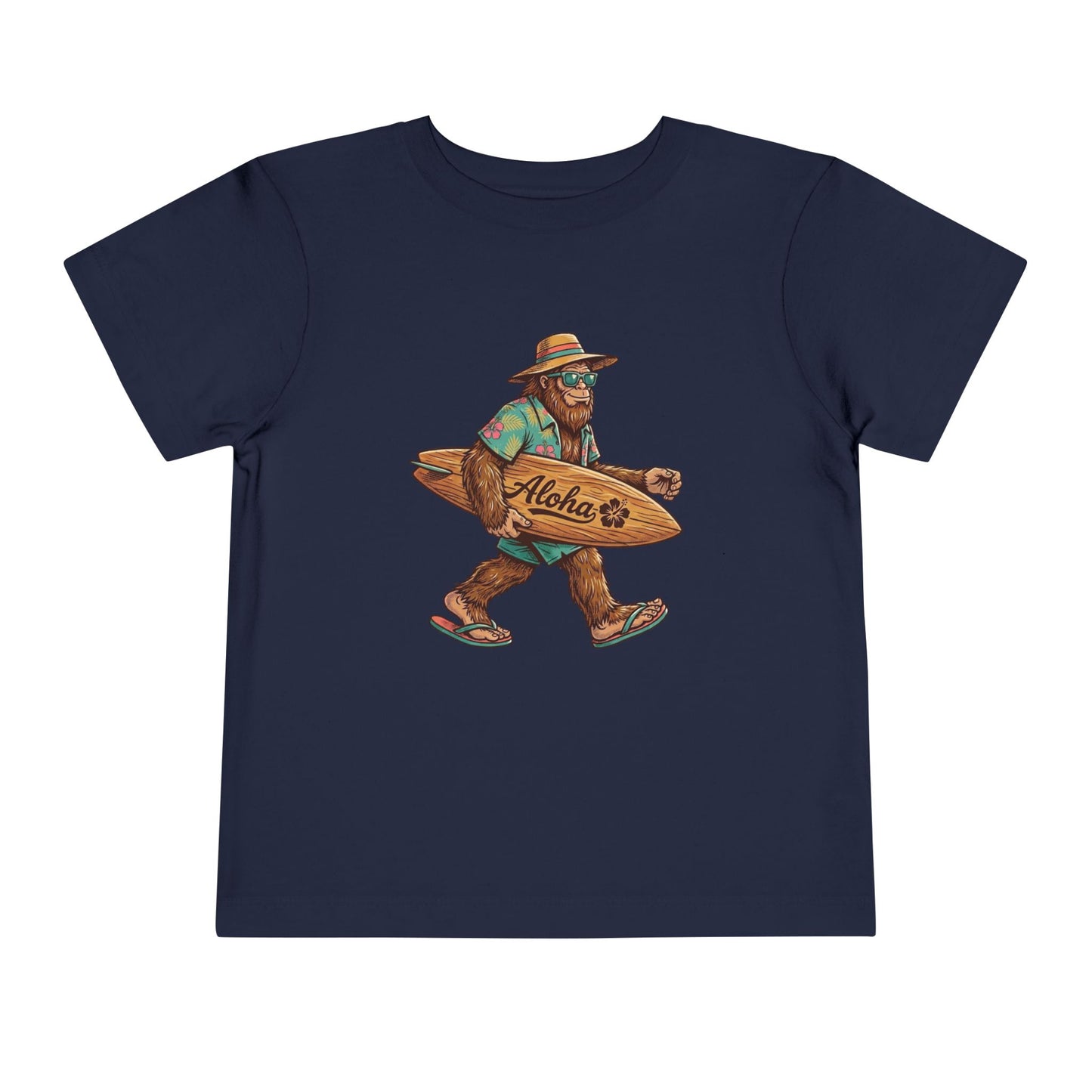Bella + Canvas 3001T toddler t-shirt in navy featuring a tropical Bigfoot wearing sunglasses and flip flops while carrying an “Aloha” surfboard.
