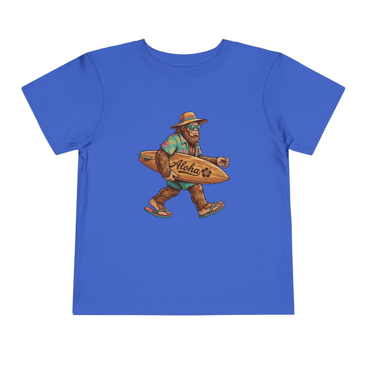 Bella + Canvas 3001T toddler t-shirt in true royal blue featuring a tropical Bigfoot wearing sunglasses and flip flops while carrying an “Aloha” surfboard.
