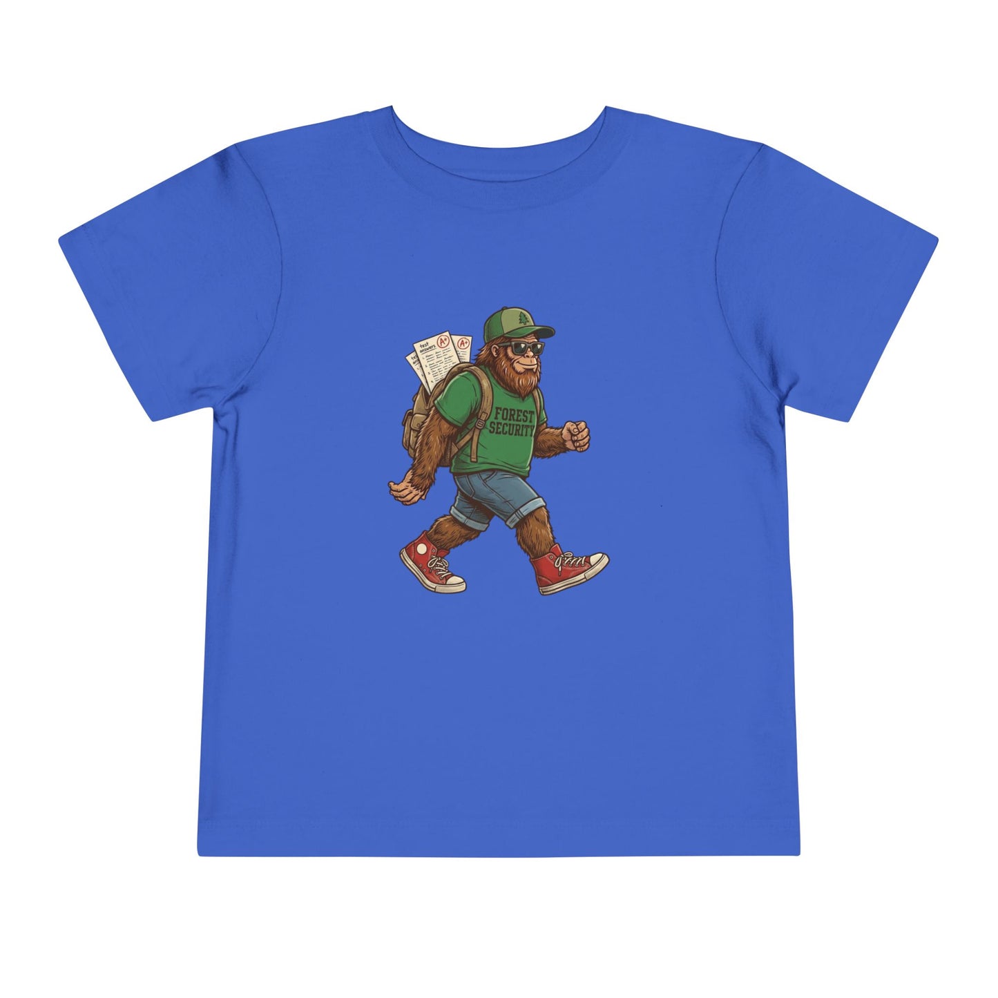 Bella + Canvas 3001T toddler t-shirt in true royal blue featuring a walking Bigfoot student graphic wearing sunglasses, a green Forest Security shirt, backpack with school papers, denim shorts, and red sneakers. Fun back-to-school toddler shirt displayed on a neutral background.