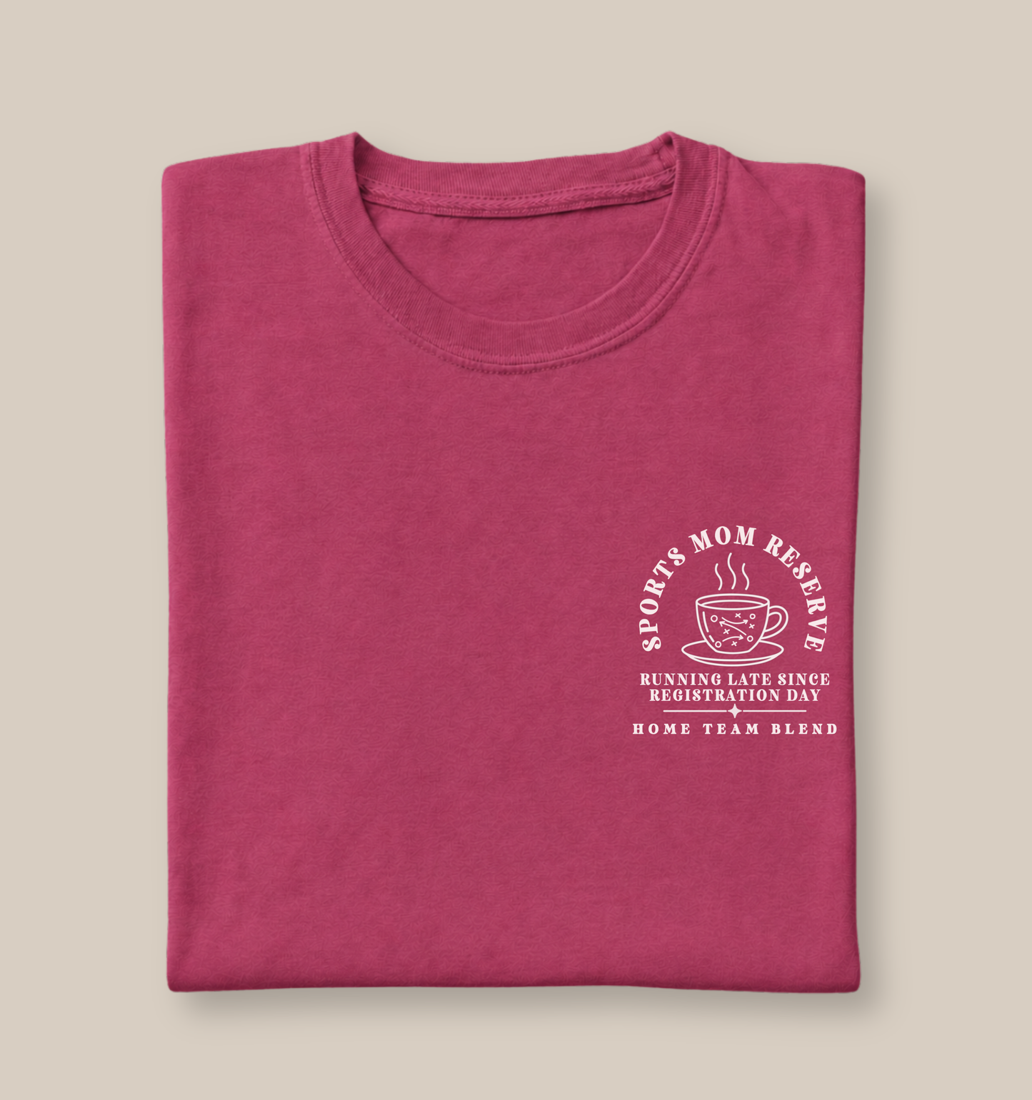 Bella + Canvas 3001 unisex t-shirt in Berry featuring the "Sports Mom Reserve" coffee-inspired pocket graphic with a steaming coffee cup and the phrase "Running Late Since Registration Day – Home Team Blend." A funny sports mom shirt perfect for busy moms juggling practices, tournaments, carpools, and game days.