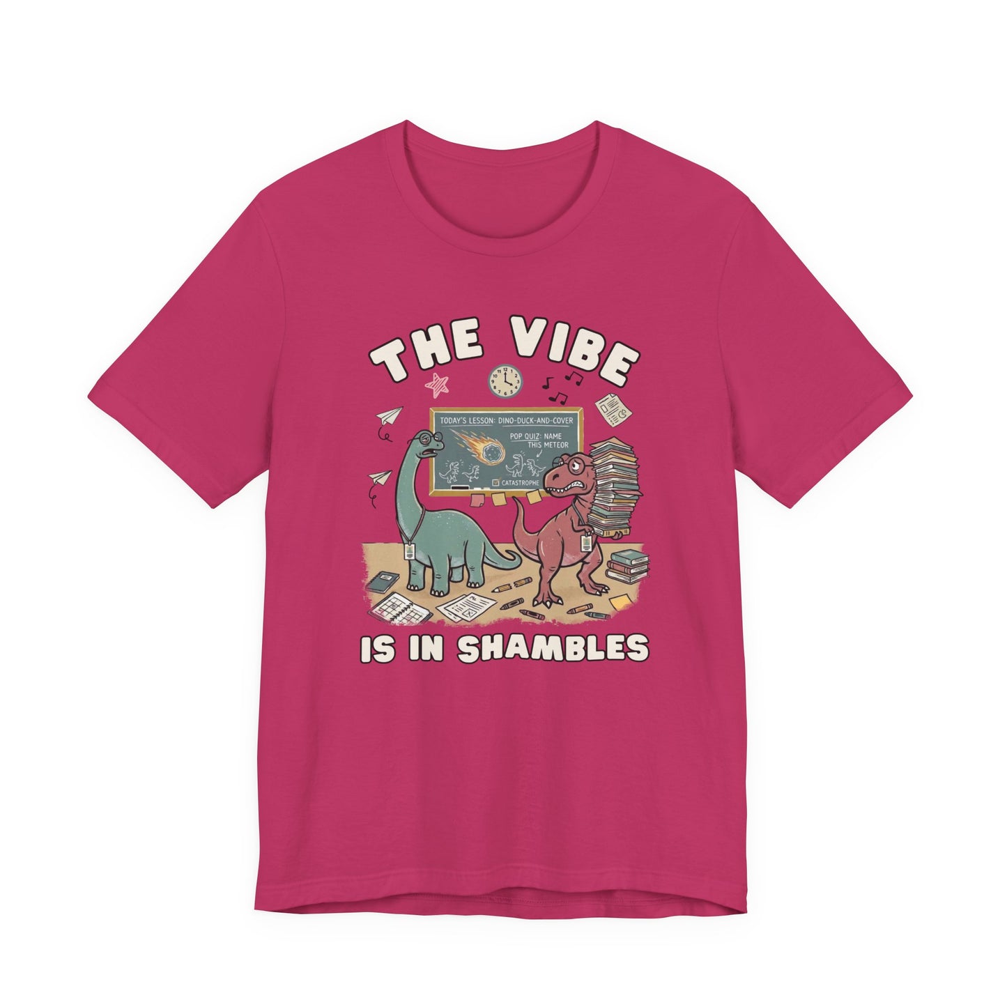 Bella + Canvas 3001 berry teacher t-shirt featuring two stressed dinosaurs in a chaotic classroom surrounded by books, papers, and a chalkboard. Funny teacher graphic tee with "The Vibe Is In Shambles" design, perfect for teachers, educators, classroom wear, back-to-school outfits, and teacher appreciation gifts.