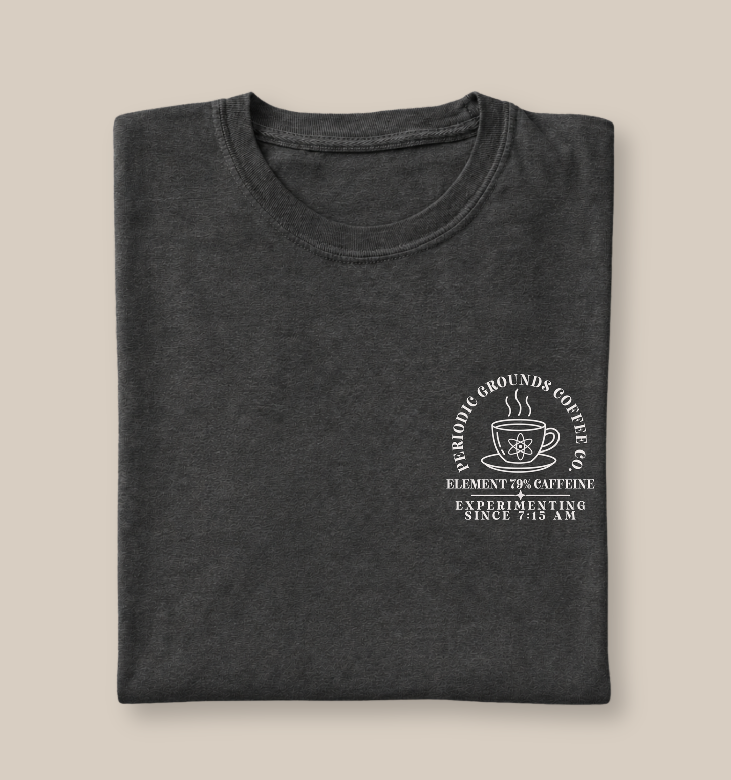 Bella + Canvas 3001 t-shirt in Dark Grey Heather featuring a Periodic Grounds Coffee Co. pocket design with a steaming coffee mug, atom symbol, and the phrases "Element 79% Caffeine" and "Experimenting Since 7:15 AM." A fun science teacher shirt for chemistry teachers, STEM educators, and coffee lovers.