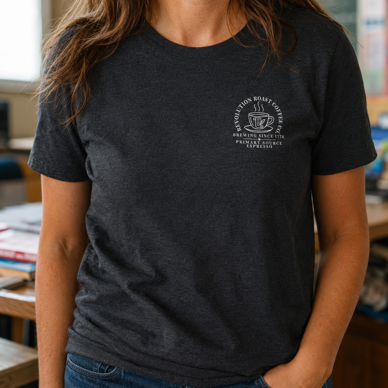 Bella + Canvas 3001 unisex t-shirt in Dark Grey Heather featuring a white Revolution Roast Coffee Co. pocket-style graphic with a vintage coffee mug, history-inspired design, and the phrases "Brewing Since 1776" and "Primary Source Espresso." A comfortable history teacher shirt for coffee lovers and educators.