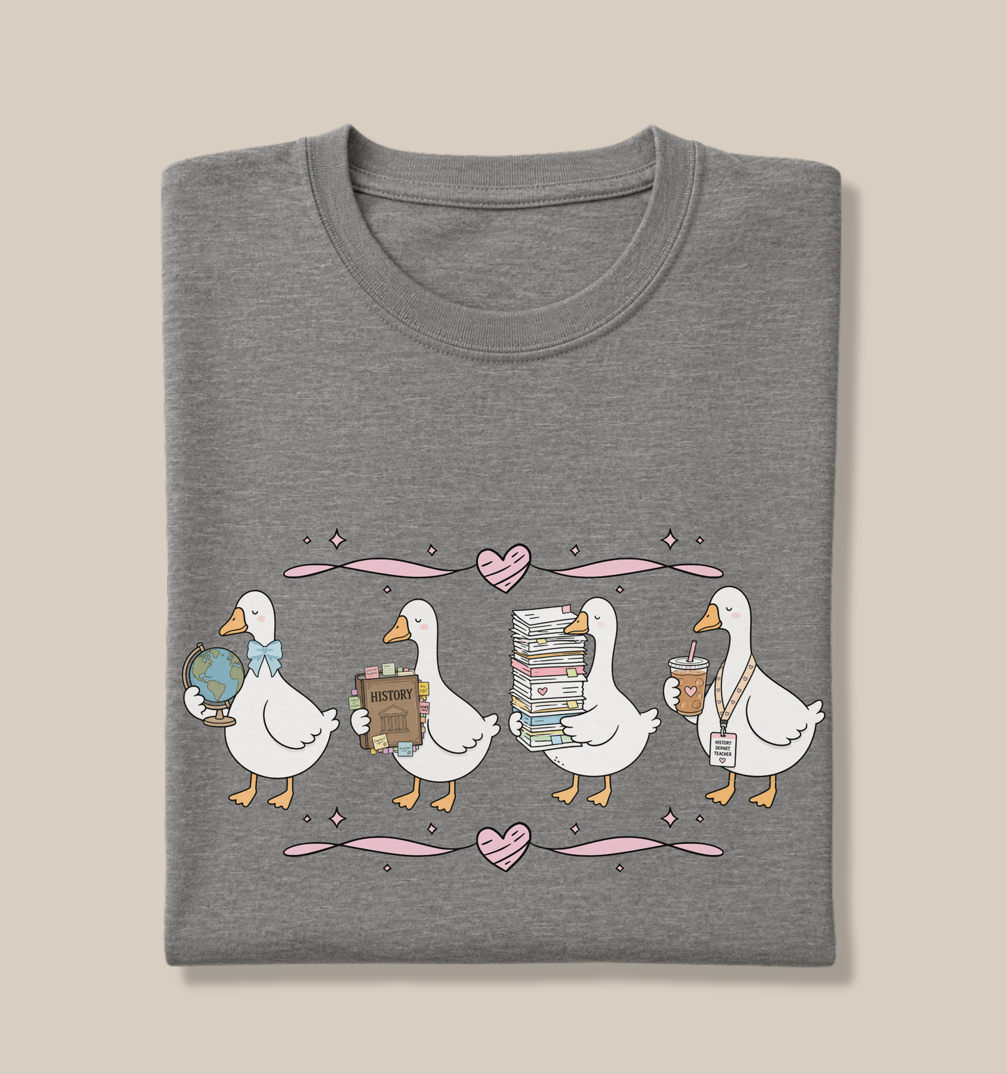 Bella + Canvas 3001 t-shirt in Deep Heather featuring a coquette history teacher goose design. Four white geese hold a globe, history textbook, stack of papers, and iced coffee with a history teacher lanyard. Pink hearts and ribbon accents add a playful touch. This cute history teacher shirt is perfect for social studies educators, back-to-school outfits, teacher appreciation gifts, and everyday classroom wear.