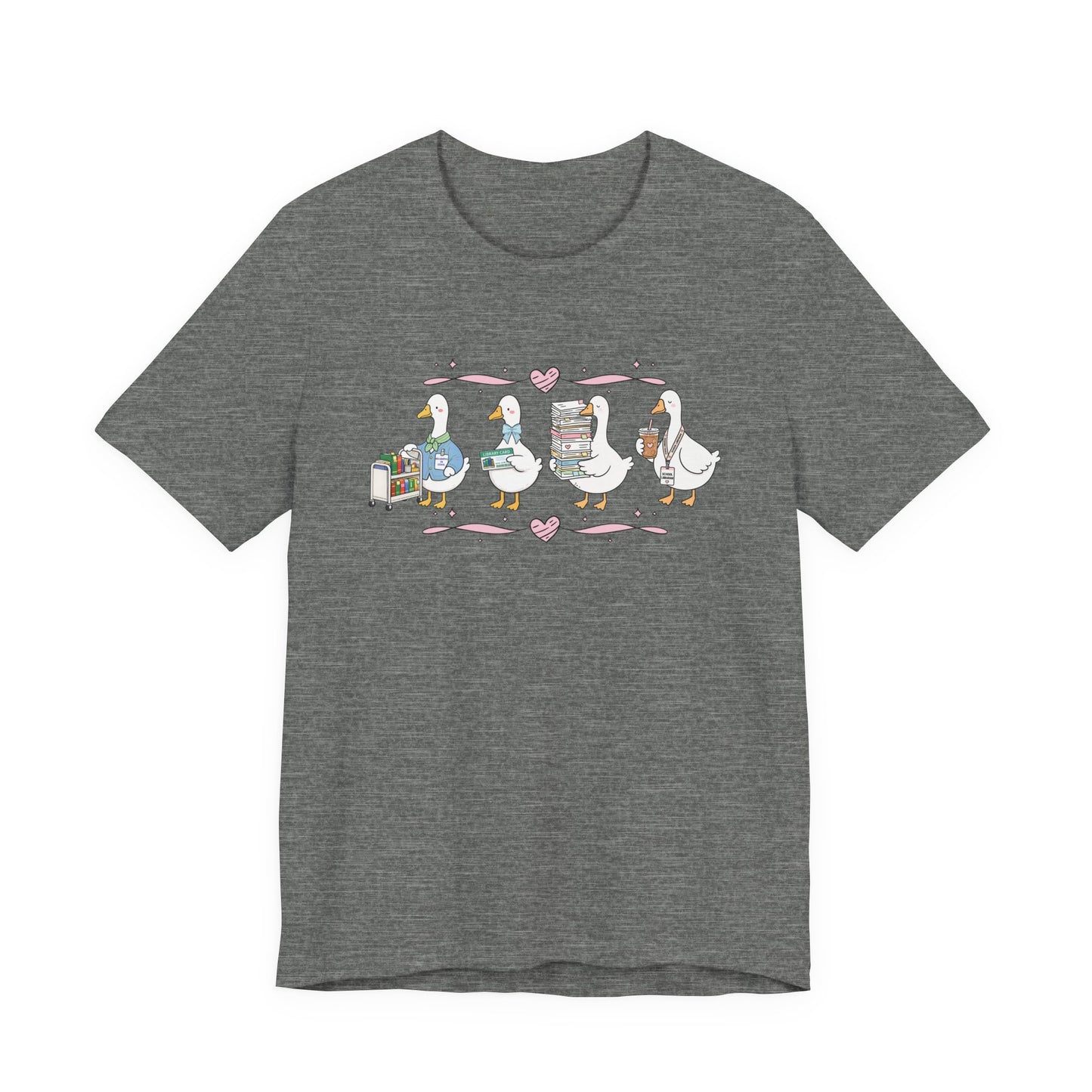 Bella + Canvas 3001 t-shirt in Deep Heather featuring a coquette librarian goose design. Four white geese display a library book cart, library card, stack of books, and iced coffee with a school librarian badge. Pink hearts and ribbon accents add a whimsical touch, making this cute librarian shirt perfect for school librarians, media specialists, library staff, book lovers, teacher appreciation gifts, and back-to-school outfits.