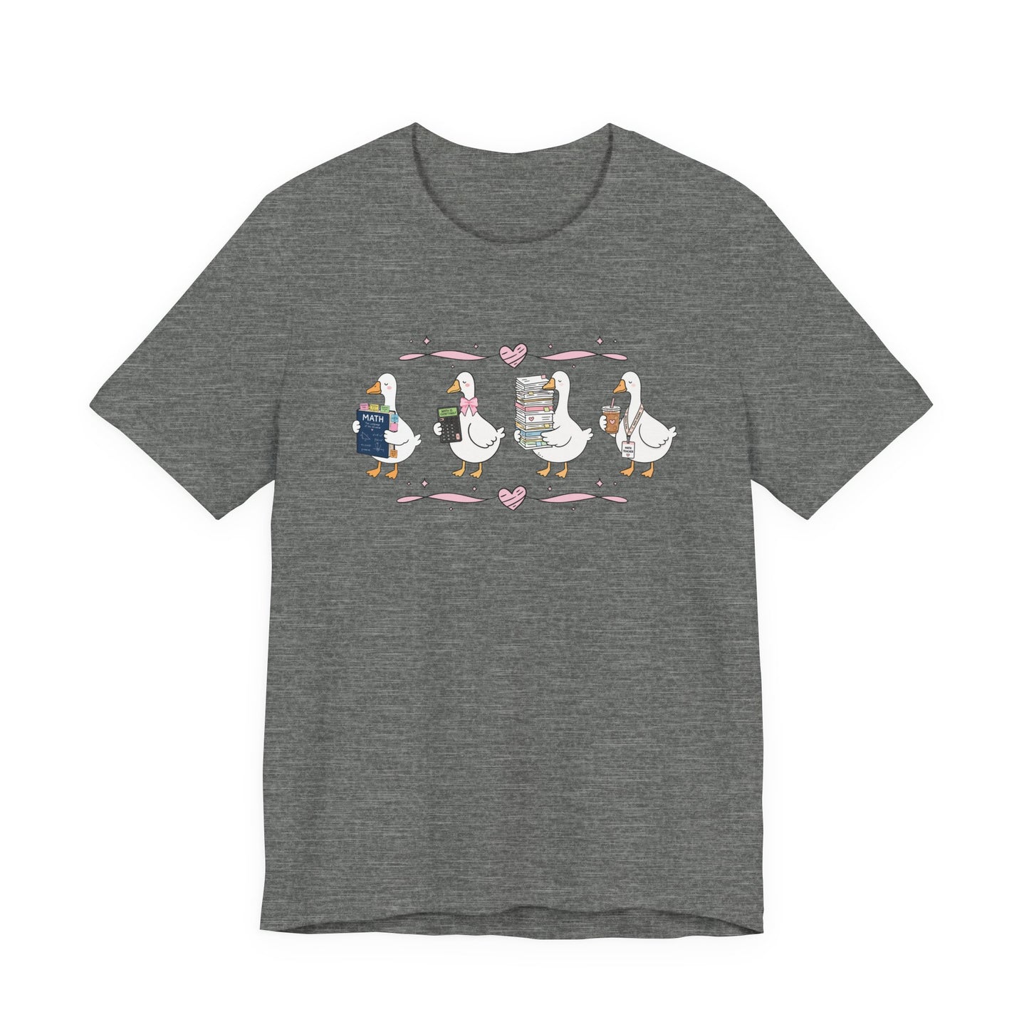 Bella + Canvas 3001 t-shirt in Deep Heather featuring a coquette math teacher goose design. Four white geese carry a math textbook, calculator, stack of papers, and iced coffee with a teacher lanyard. Pink bows and heart accents add a playful touch to this cute math teacher shirt, perfect for back-to-school outfits, teacher appreciation gifts, and everyday classroom wear.