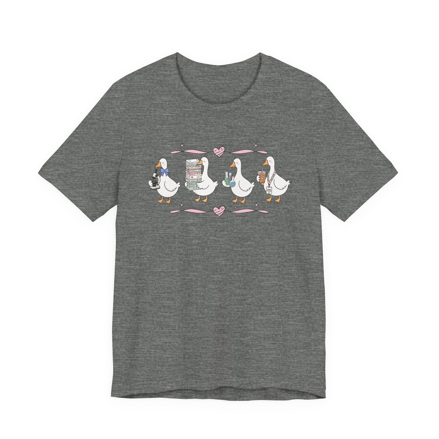 Bella + Canvas 3001 t-shirt in Deep Heather featuring a coquette science teacher goose design. Four white geese hold a microscope, a stack of classroom papers, science beakers filled with colorful experiments, and an iced coffee with a science teacher lanyard. Pink hearts and ribbon accents add a whimsical touch, making this cute science teacher shirt perfect for back-to-school outfits, teacher appreciation gifts, and everyday classroom wear.