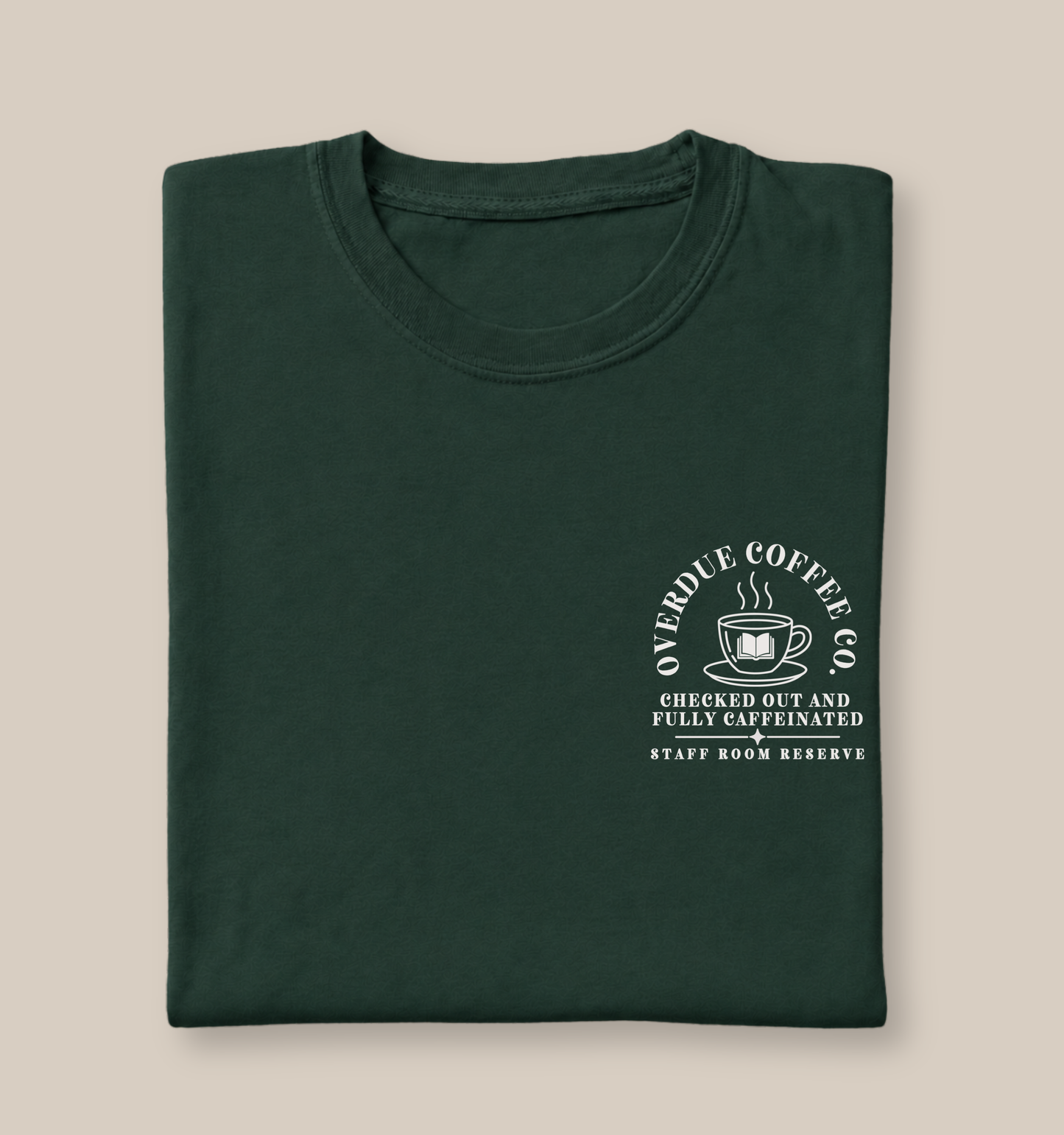 Bella + Canvas 3001 unisex t-shirt in Forest featuring a white Overdue Coffee Co. pocket-style graphic with a steaming coffee cup and open book illustration. The design reads "Checked Out and Fully Caffeinated" and "Staff Room Reserve," making it a cozy graphic tee for librarians, library staff, book lovers, and coffee enthusiasts.