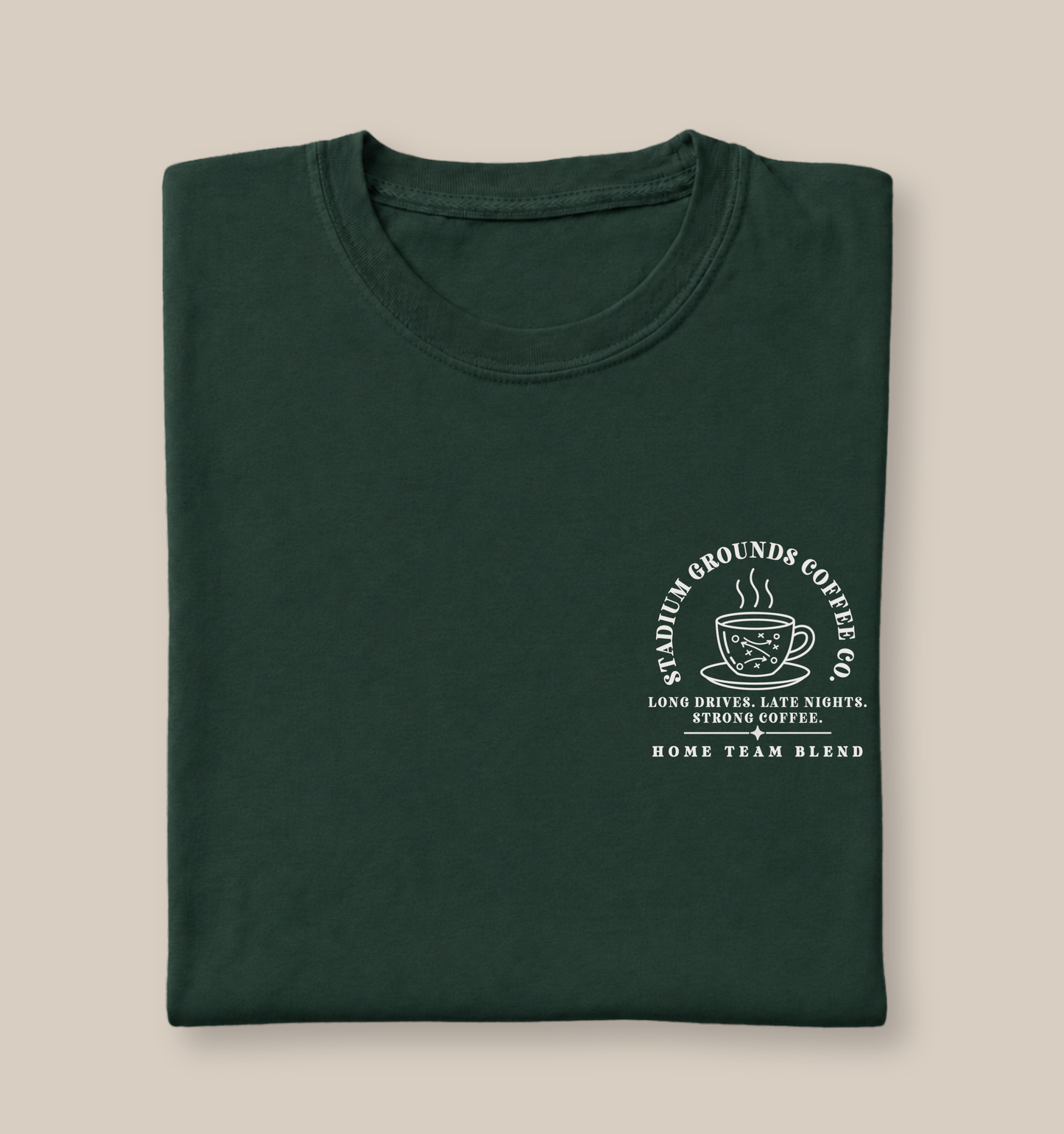 Bella + Canvas 3001 unisex t-shirt in Forest featuring a white pocket-style "Stadium Grounds Coffee Co." graphic with a football play coffee cup design. The graphic reads "Long Drives. Late Nights. Strong Coffee. Home Team Blend," making it the perfect football mom shirt for Friday night lights, weekend tournaments, tailgates, and cheering on the home team.