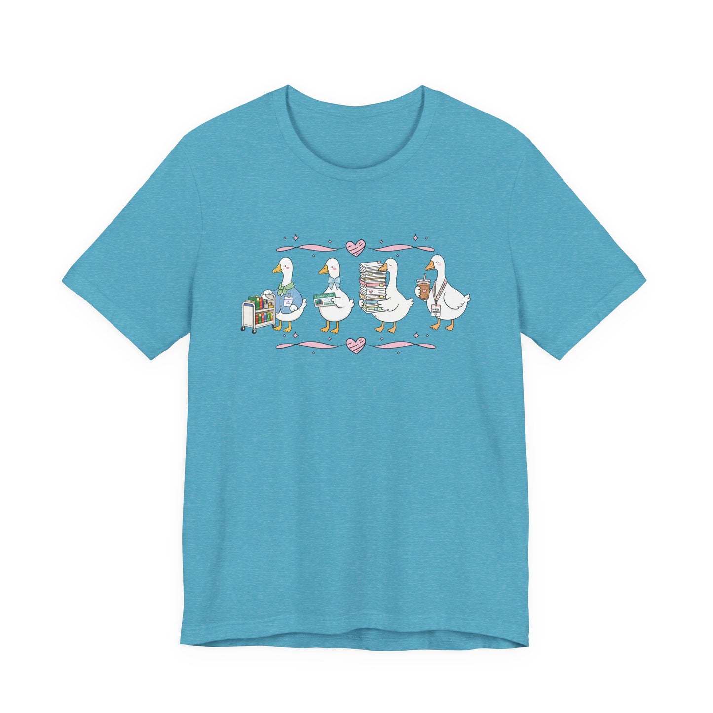 Bella + Canvas 3001 t-shirt in Heather Aqua featuring a coquette librarian goose design. Four white geese display a book cart, library card, stack of books, and iced coffee with a school librarian badge. Pink hearts and ribbon accents add a playful touch, making this cute librarian shirt perfect for school librarians, media specialists, library staff, book lovers, teacher appreciation gifts, and back-to-school outfits.