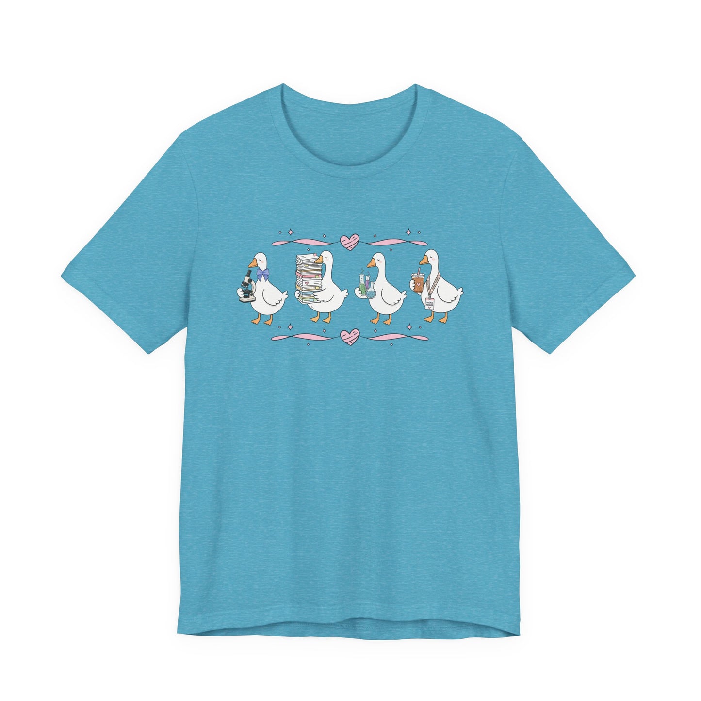 Bella + Canvas 3001 t-shirt in Heather Aqua featuring a coquette science teacher goose design. Four white geese hold a microscope, a stack of classroom papers, science beakers filled with colorful experiments, and an iced coffee with a science teacher lanyard. Pink hearts and ribbon accents add a playful touch, making this cute science teacher shirt perfect for back-to-school outfits, teacher appreciation gifts, and everyday classroom wear.