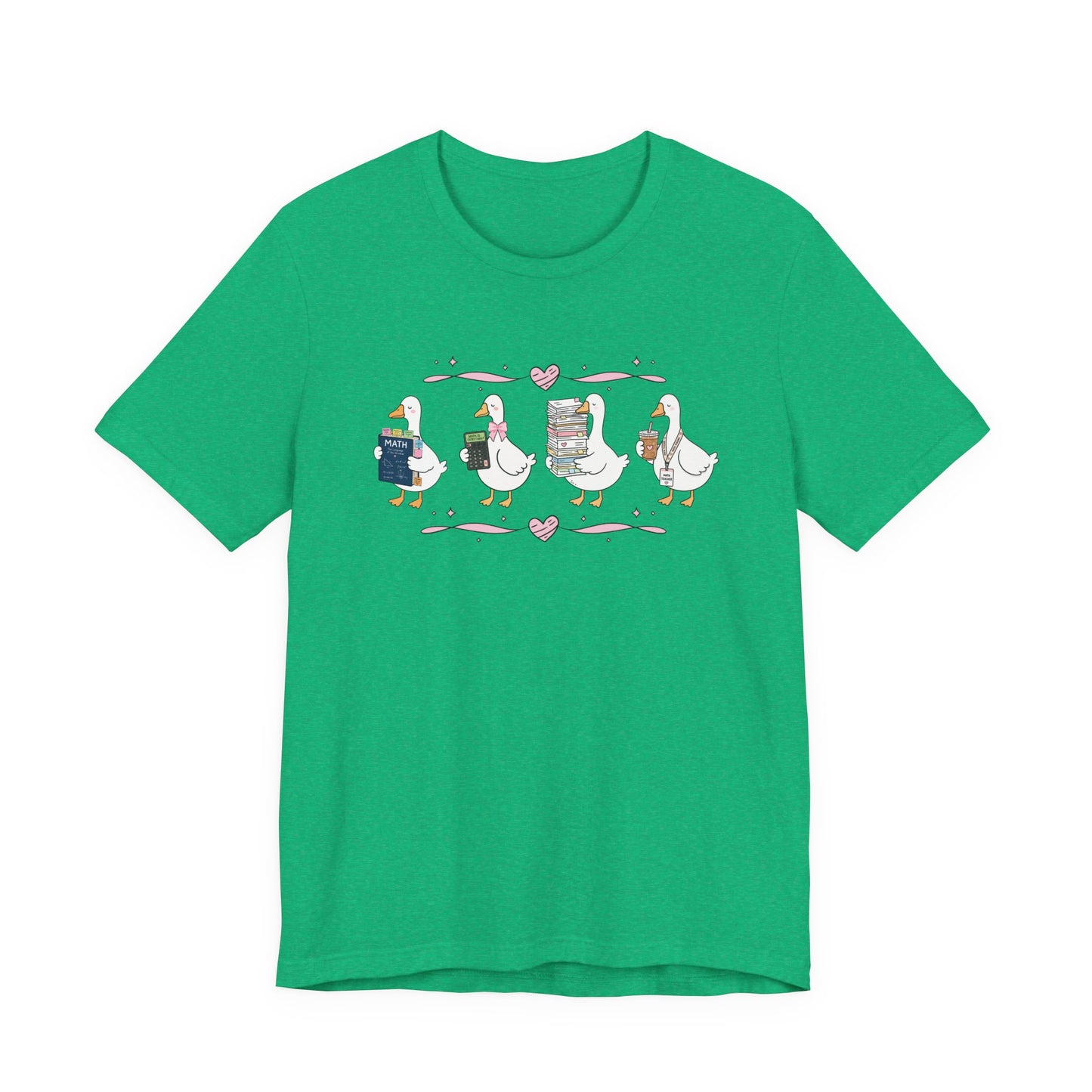Bella + Canvas 3001 t-shirt in Heather Kelly featuring a coquette math teacher goose design. Four white geese hold a math textbook, calculator, stack of graded papers, and iced coffee with a teacher badge. Pink bows and heart accents create a fun classroom-inspired look. A perfect math teacher shirt for back-to-school, teacher appreciation gifts, and everyday school wear.