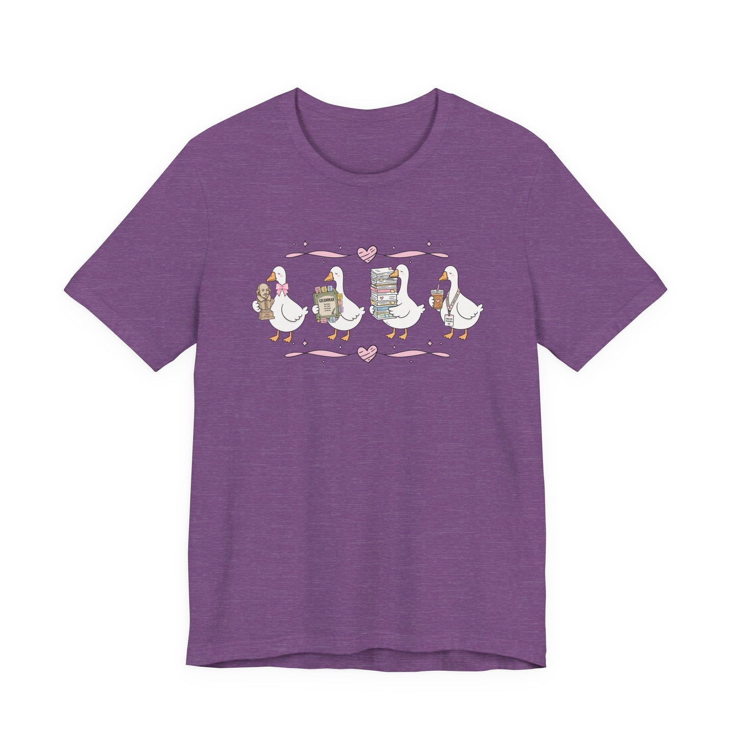 Bella + Canvas 3001 t-shirt in Heather Team Purple featuring a coquette English teacher goose design. Four white geese carry a classic literature bust, a grammar book, a stack of books and papers, and an iced coffee with an English teacher lanyard. Pink hearts and ribbon accents add a playful touch, making this cute English teacher shirt perfect for back-to-school outfits, teacher appreciation gifts, and everyday classroom wear.