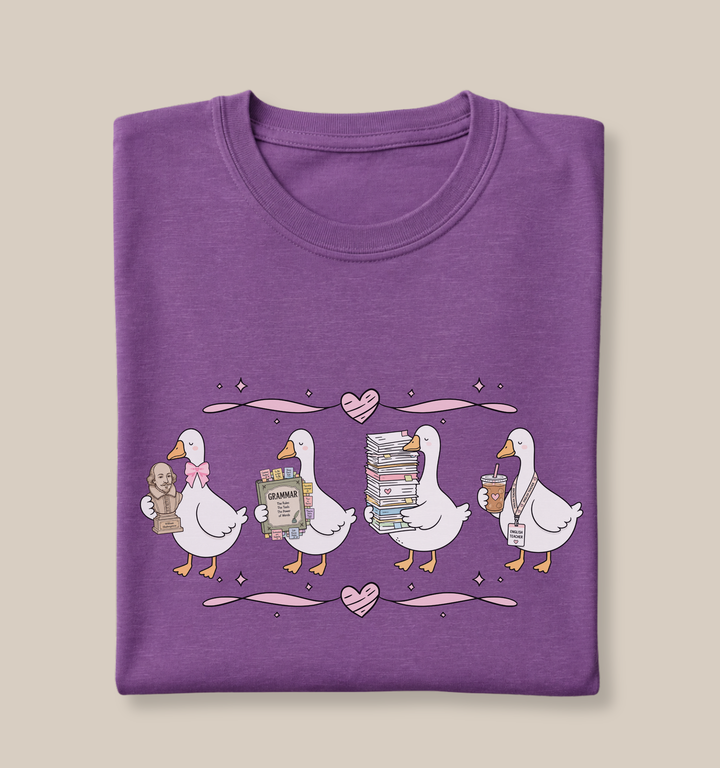 Bella + Canvas 3001 t-shirt in Heather Team Purple featuring a coquette English teacher goose design. Four white geese carry a classic author bust, a grammar book covered in sticky notes, a tall stack of books and papers, and an iced coffee with an English teacher lanyard. Pink hearts and ribbon accents add a whimsical touch, making this cute English teacher shirt perfect for back-to-school outfits, teacher appreciation gifts, and everyday classroom wear.