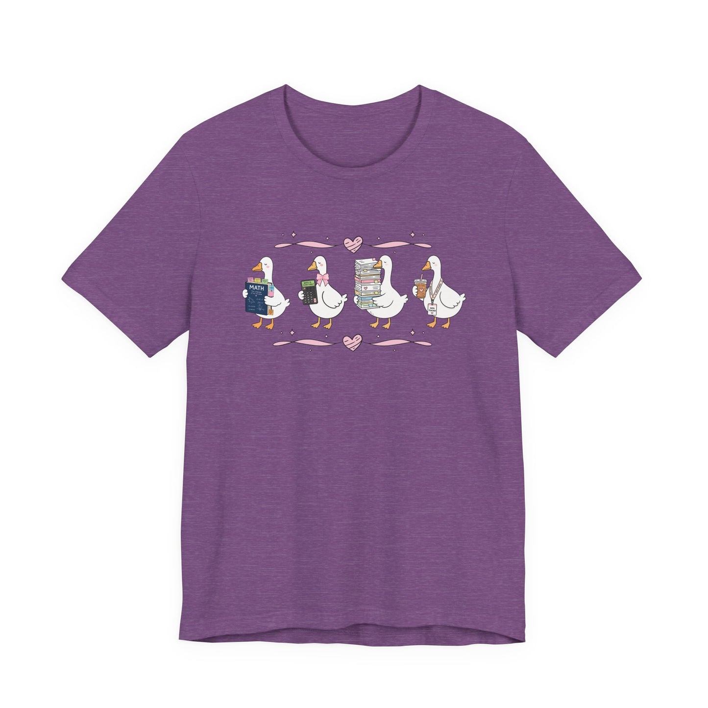 Bella + Canvas 3001 t-shirt in Heather Team Purple featuring a coquette math teacher goose design. Four white geese carry a math textbook, calculator, stack of papers, and iced coffee with a teacher lanyard. Pink bows and heart accents add a playful touch, making this a cute math teacher shirt for back-to-school, teacher appreciation gifts, and everyday classroom style.