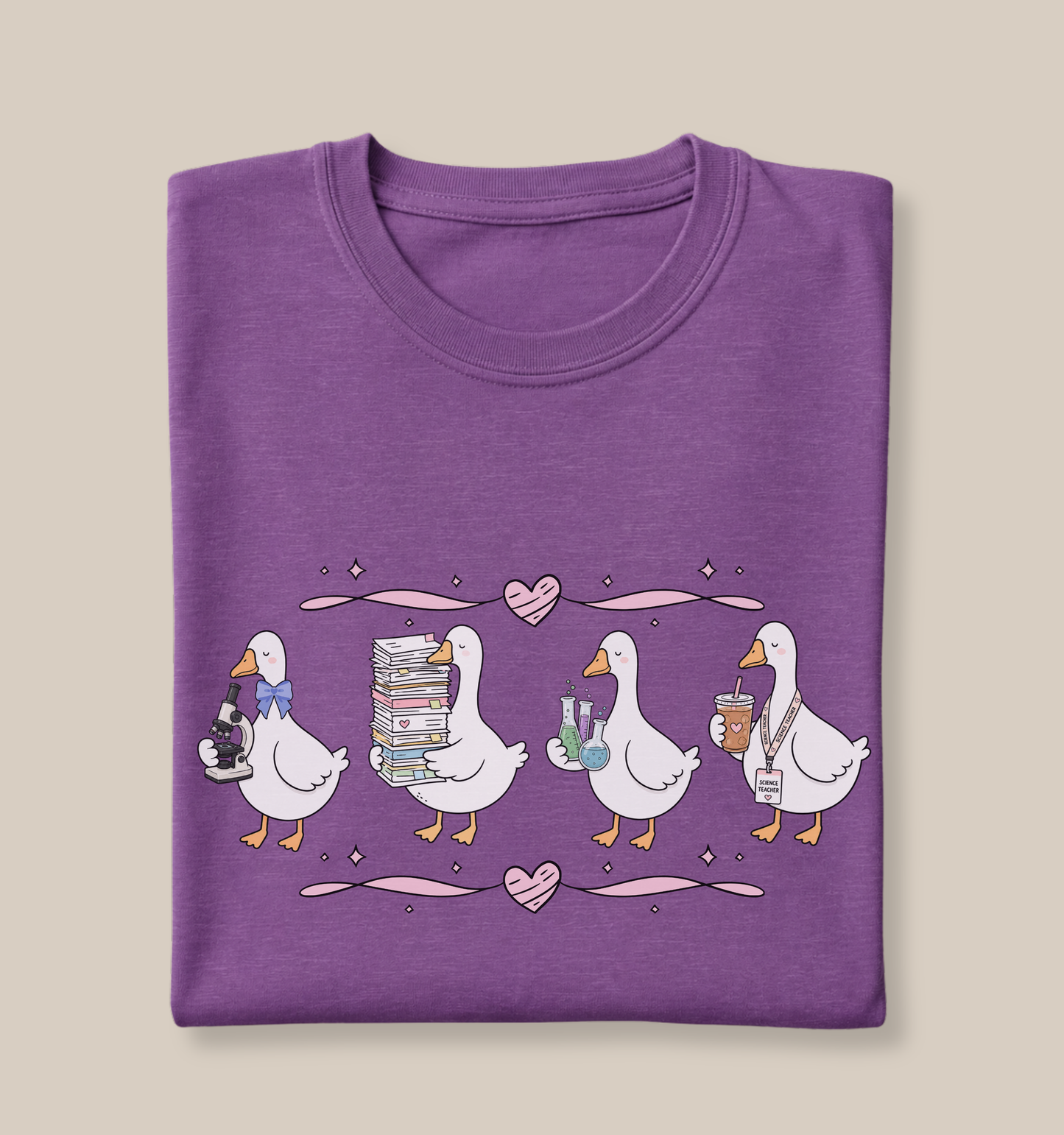 Bella + Canvas 3001 t-shirt in Heather Team Purple featuring a coquette science teacher goose design. Four white geese hold a microscope, a tall stack of classroom papers, science beakers with colorful experiments, and an iced coffee with a science teacher lanyard. Pink hearts and ribbon accents add a whimsical touch, making this cute science teacher shirt perfect for back-to-school outfits, teacher appreciation gifts, and everyday classroom wear.