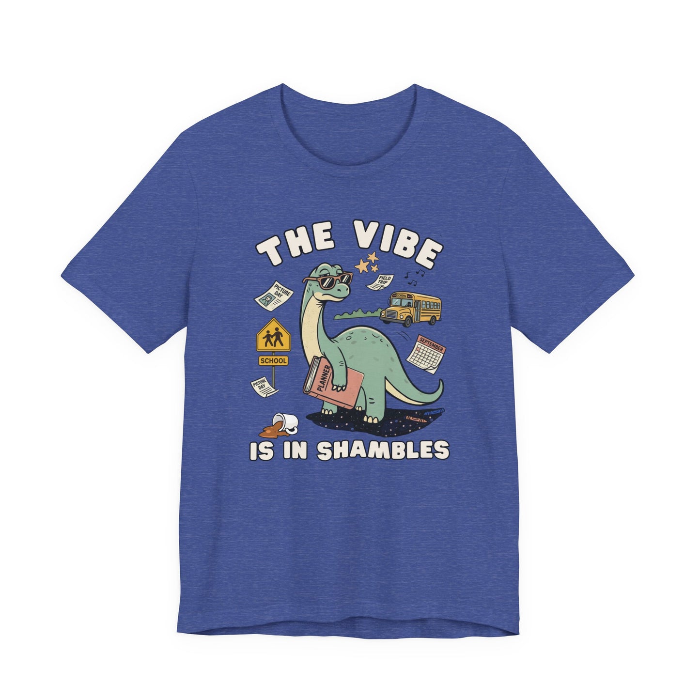 Bella + Canvas 3001 heather true royal blue t-shirt featuring a humorous teacher dinosaur design with the phrase "The Vibe Is In Shambles." The graphic shows a dinosaur holding a planner and surrounded by a school bus, classroom supplies, a spilled coffee cup, a calendar, and back-to-school icons. Perfect for teachers, educators, school staff, elementary teachers, and anyone navigating the busy school year with humor and style.