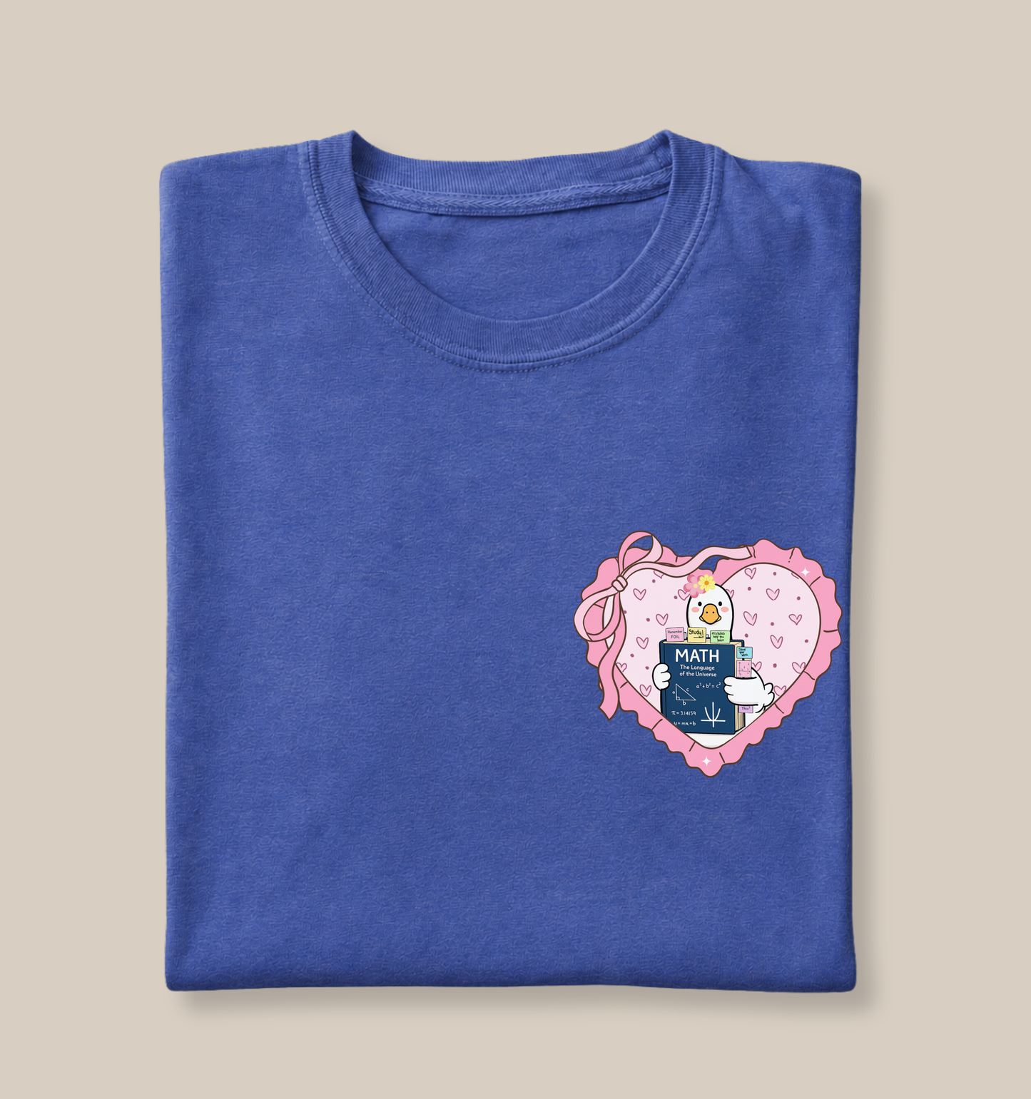 Bella + Canvas 3001 t-shirt in Heather True Royal featuring a coquette math teacher goose heart design on the left chest. The artwork shows a white goose holding a math textbook inside a pink heart with ribbon bow accents and floral details. Perfect for math teachers, algebra teachers, geometry teachers, STEM educators, teacher appreciation gifts, and back-to-school teacher apparel.