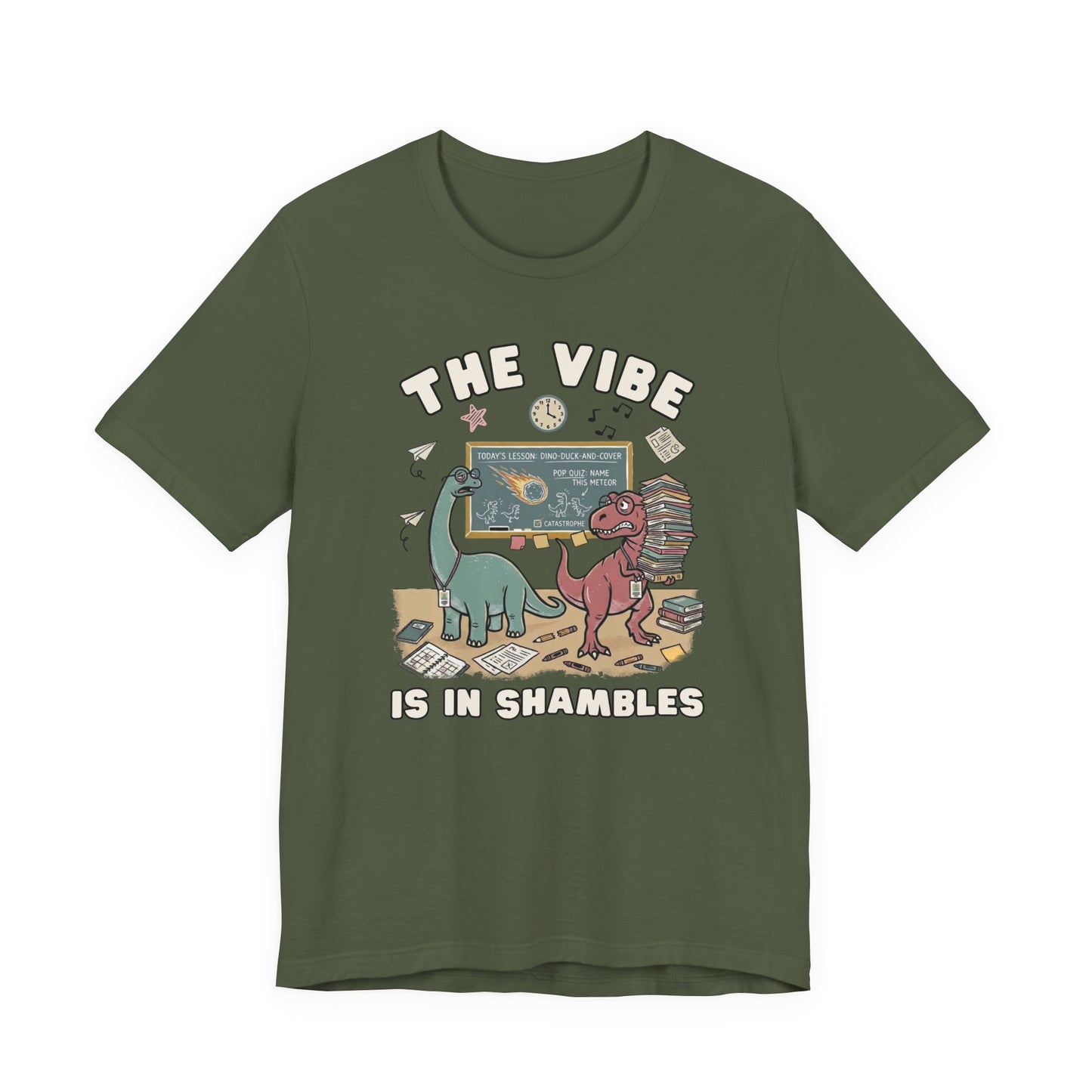 Bella + Canvas 3001 military green teacher t-shirt featuring two stressed dinosaurs in a chaotic classroom with books, papers, and a chalkboard. Funny teacher shirt with "The Vibe Is In Shambles" design, perfect for elementary teachers, middle school teachers, and back-to-school gifts.