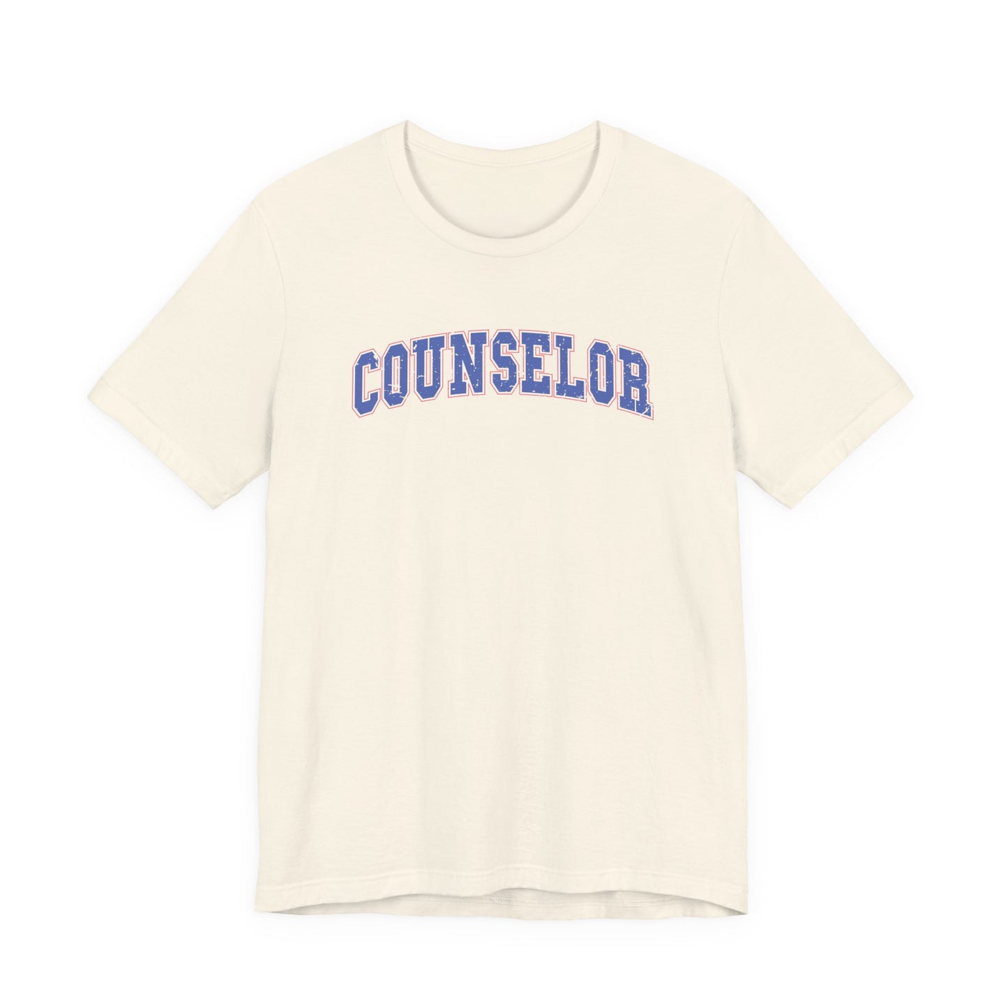 Bella + Canvas 3001 unisex t-shirt in Natural featuring a vintage varsity-style "Counselor" graphic in blue with a pink outline. A classic counselor shirt perfect for school counselors, college counselors, and everyday wear during the school year.