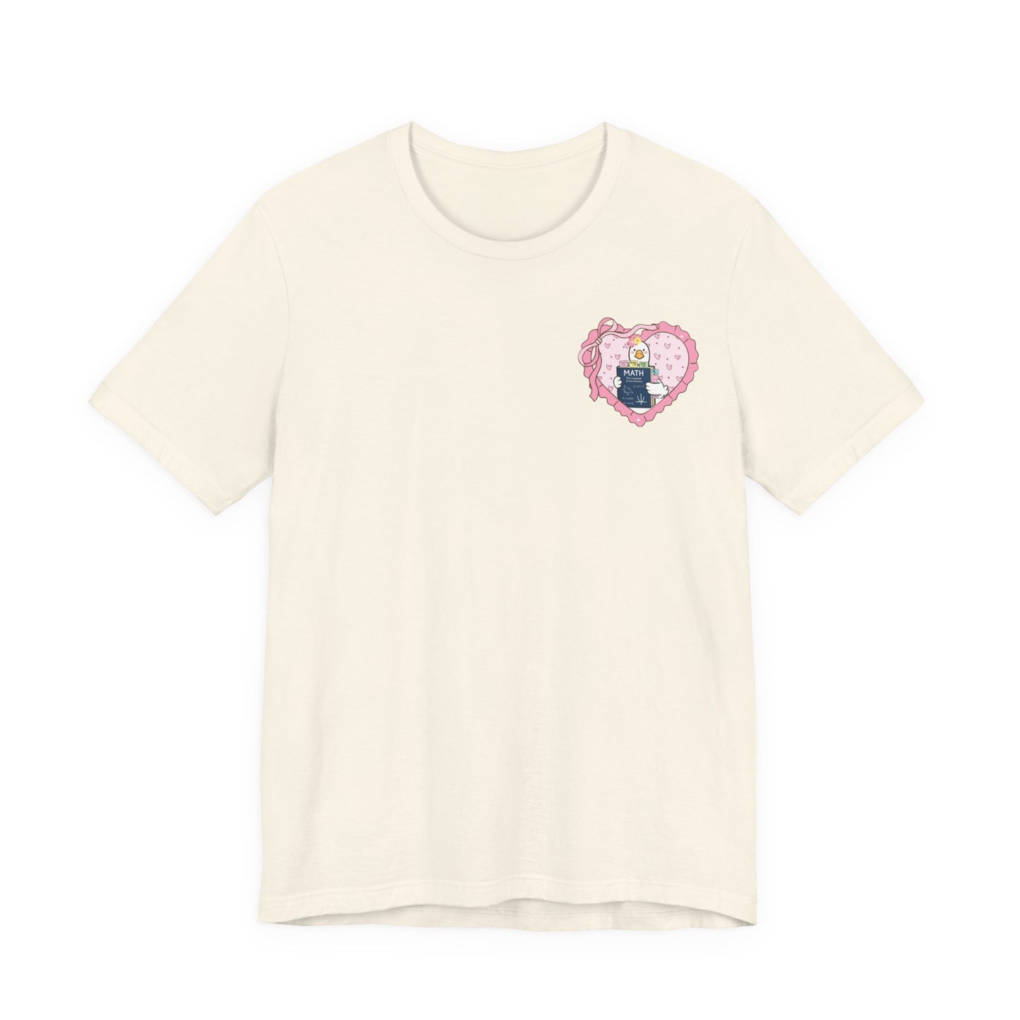 Bella + Canvas 3001 t-shirt in Natural featuring a coquette math teacher goose heart design on the left chest. The artwork showcases a white goose holding a math textbook within a pink heart frame. Perfect for math teachers, classroom staff, and teacher gift ideas.