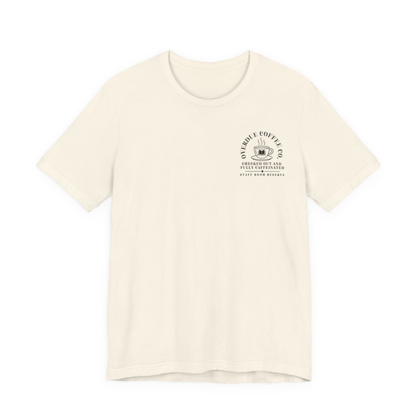 Bella + Canvas 3001 unisex t-shirt in Natural featuring a white Overdue Coffee Co. pocket-style graphic with a steaming coffee cup and book illustration. The design reads "Checked Out and Fully Caffeinated" and "Staff Room Reserve," a relaxed-fit graphic tee for librarians, teachers, and readers.