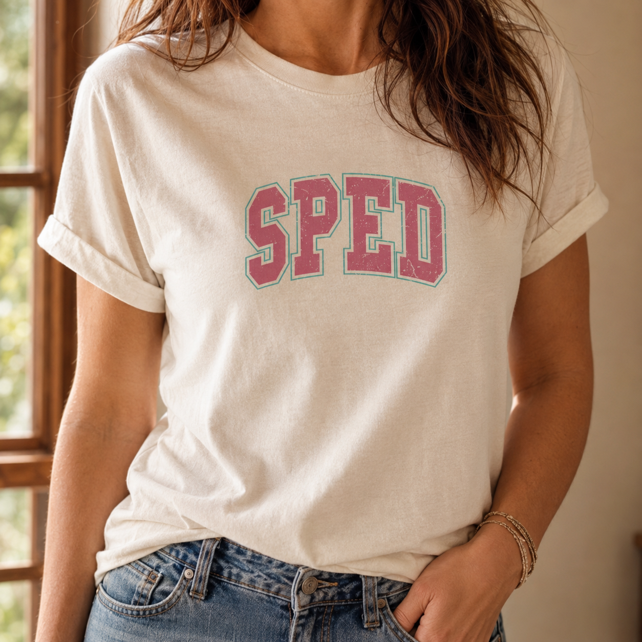 Bella + Canvas 3001 unisex t-shirt in Natural featuring a distressed retro varsity-style "SPED" graphic in pink with a mint outline. Comfortable teacher graphic tee designed for special education teachers, perfect for school, classroom wear, and back-to-school outfits.
