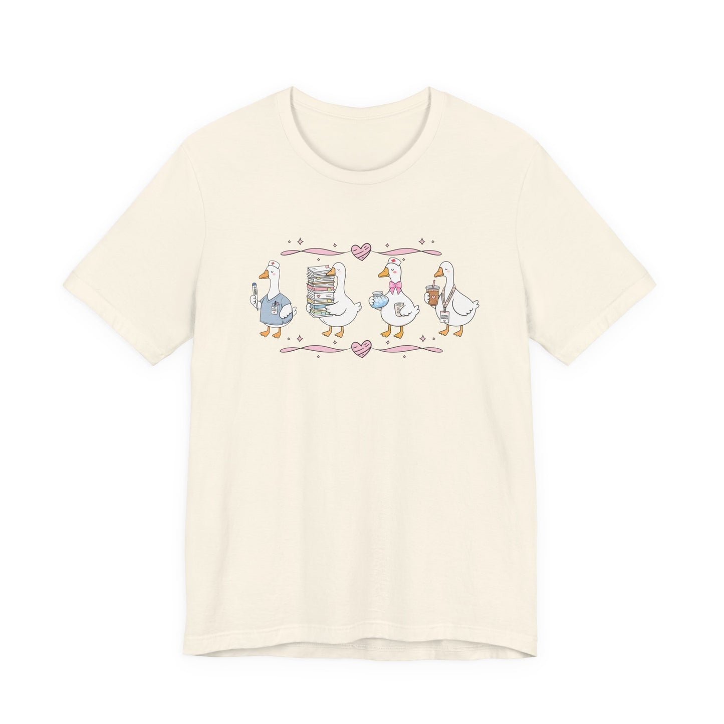 Bella + Canvas 3001 t-shirt in Natural featuring a coquette school nurse goose design. Four white geese display nurse-themed accessories including scrubs, a thermometer, medical supplies, paperwork, iced coffee, and a school nurse badge. Pink hearts and ribbon accents add a whimsical touch, making this cute school nurse shirt perfect for school nurses, healthcare workers, nurse appreciation gifts, medical staff, and back-to-school outfits.