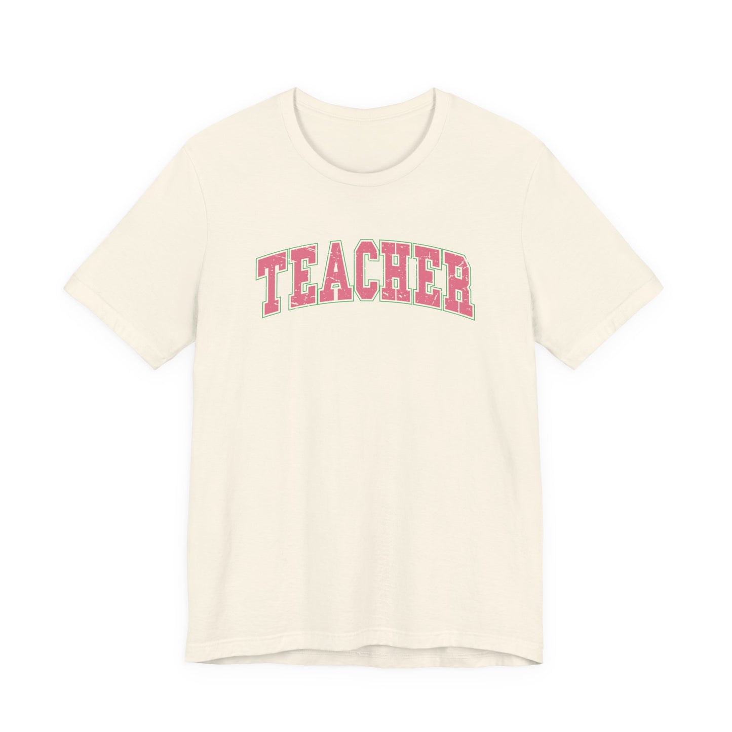 Bella + Canvas 3001 unisex t-shirt in Natural featuring a distressed varsity-style "Teacher" graphic in pink with a green outline. A comfortable teacher appreciation shirt perfect for elementary teachers, educators, back-to-school outfits, and everyday classroom wear.