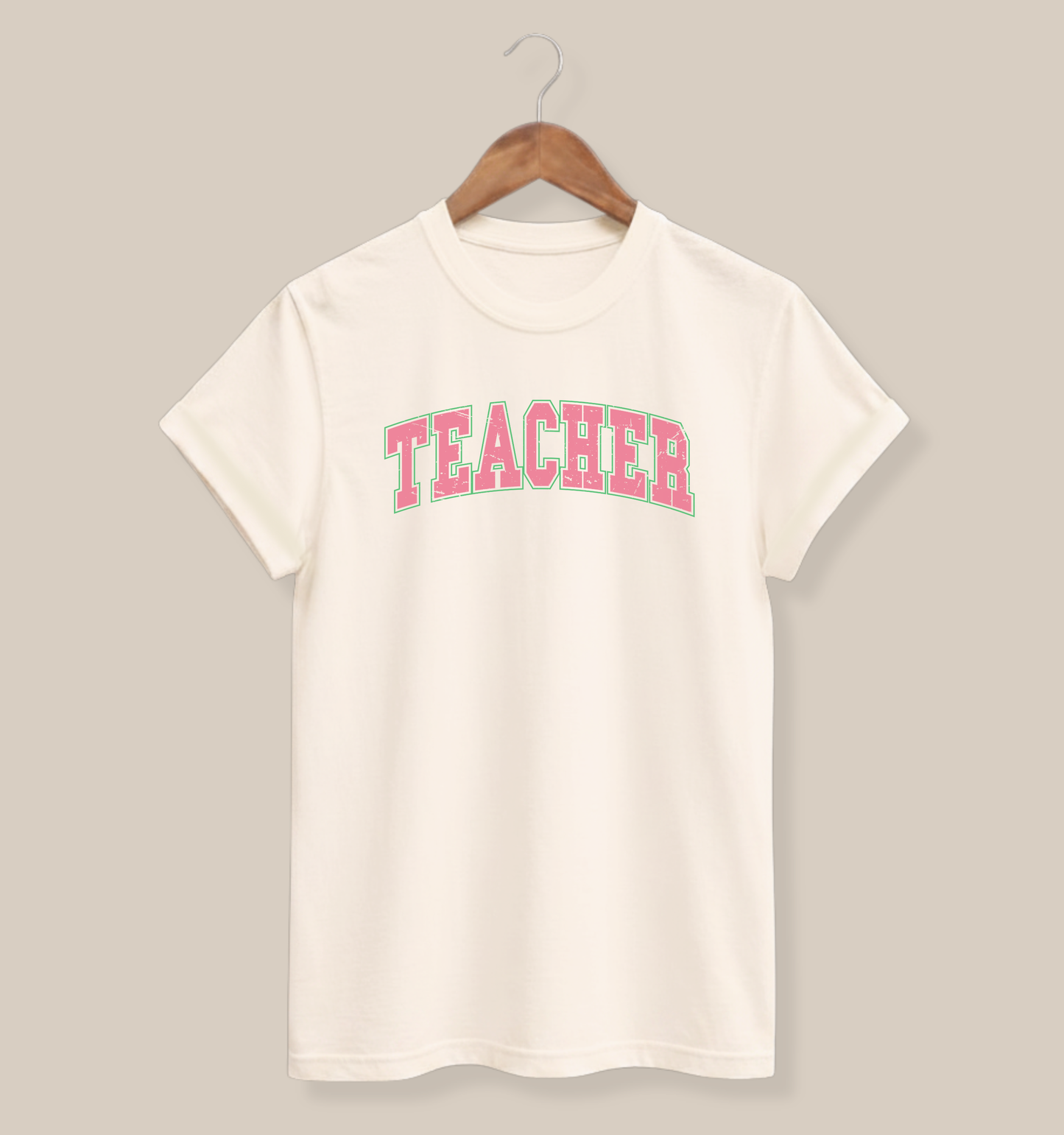Bella + Canvas 3001 unisex t-shirt in Natural featuring a distressed varsity-style "Teacher" graphic in pink with a mint green outline. A trendy teacher graphic tee perfect for educators, back-to-school outfits, classroom wear, teacher appreciation gifts, and everyday casual style.