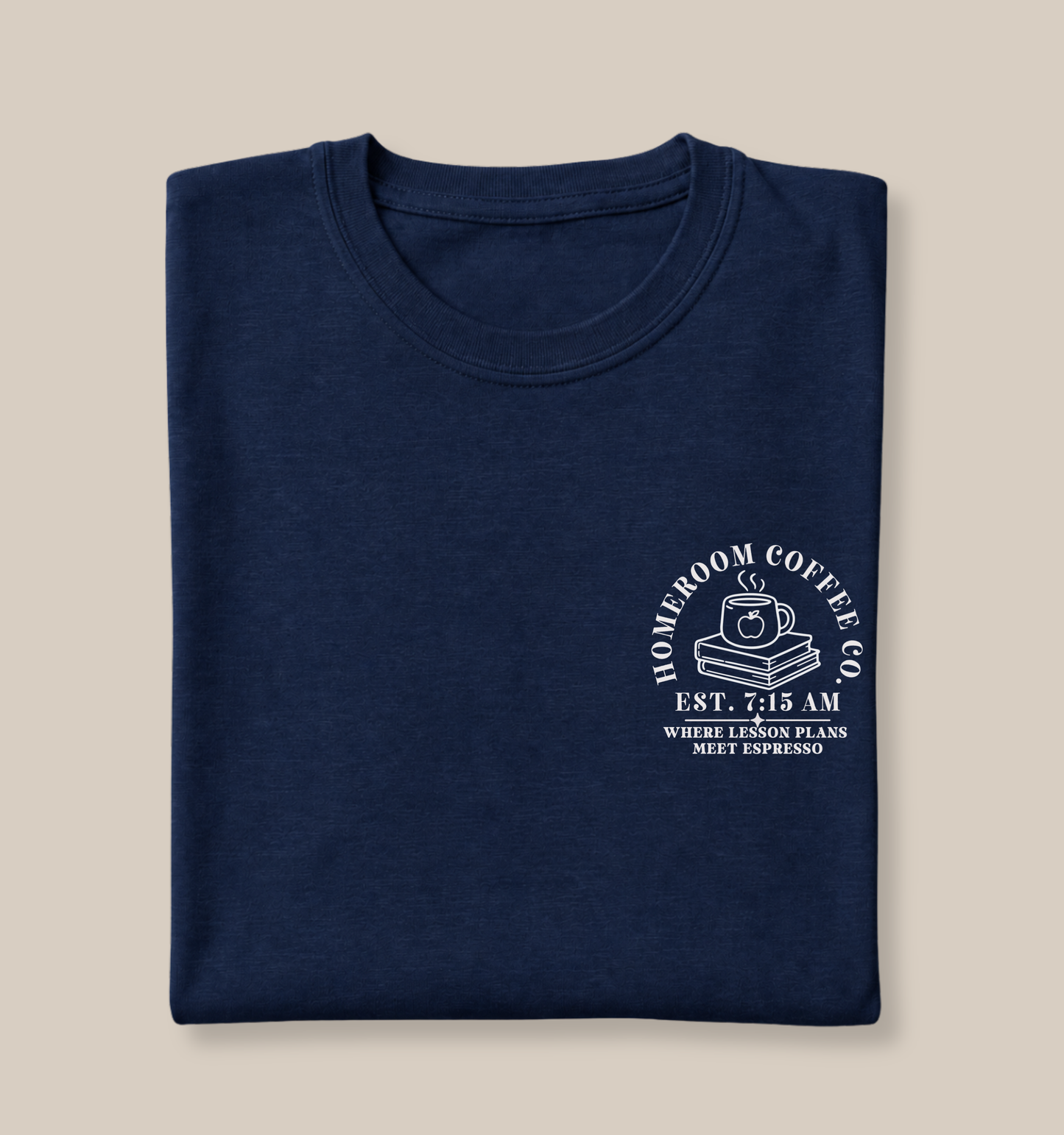 Folded Bella + Canvas 3001 t-shirt in Navy featuring a white Homeroom Coffee Co. pocket design with a steaming coffee mug on stacked books and the phrase "Where Lesson Plans Meet Espresso." A minimalist teacher shirt perfect for educators, coffee lovers, and school staff.