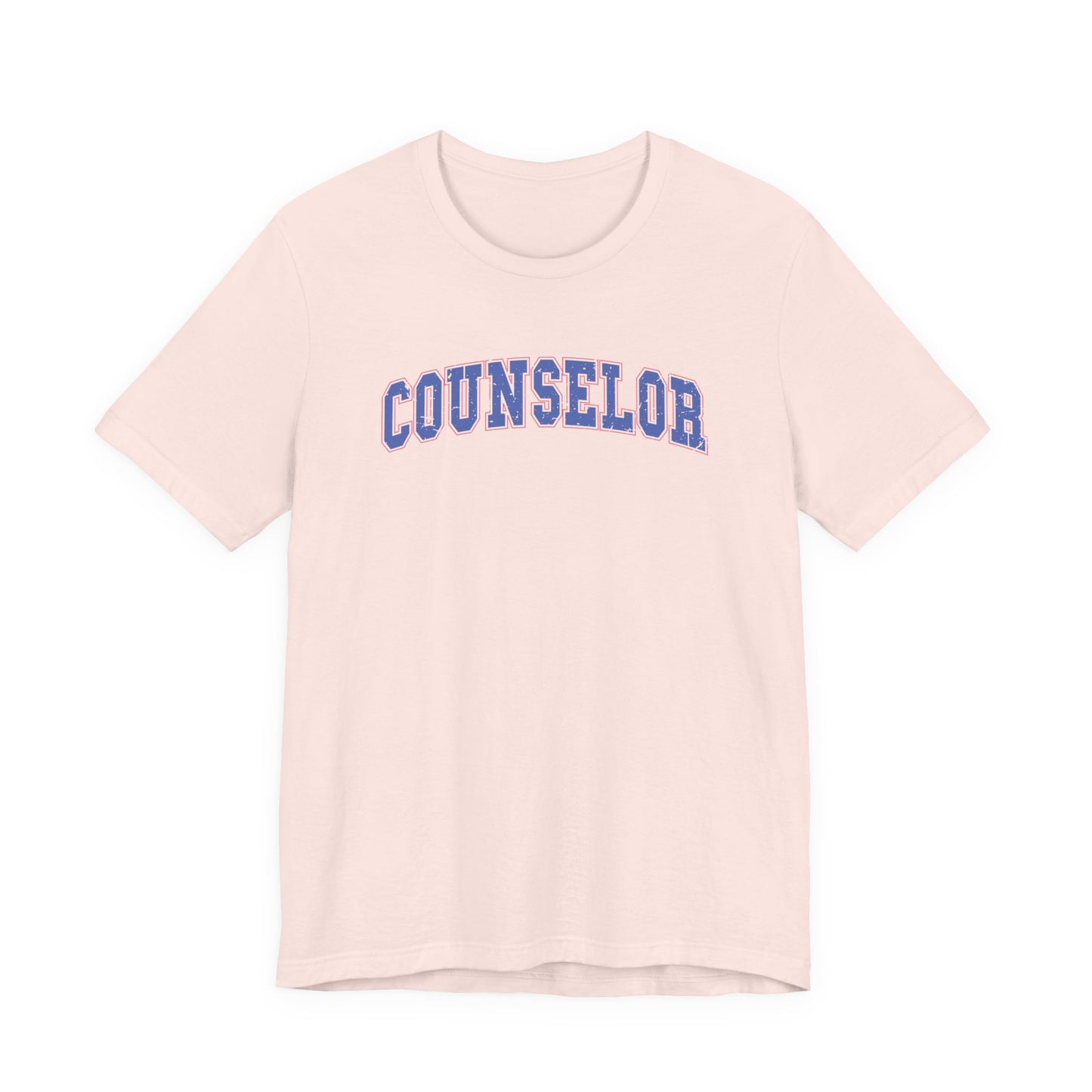Bella + Canvas 3001 unisex t-shirt in Soft Pink featuring a vintage varsity-style "Counselor" graphic in blue with a pink outline. A trendy counselor appreciation tee for school counselors, guidance counselors, and education professionals who love a collegiate-inspired style.
