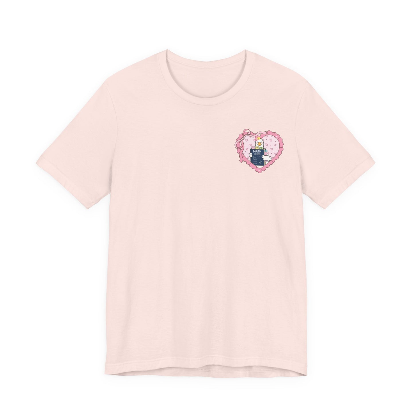 Bella + Canvas 3001 t-shirt in Soft Pink featuring a coquette math teacher goose heart design. The left chest artwork includes a white goose holding a math textbook inside a pink decorative heart. Perfect for math teachers, women educators, and classroom fashion.